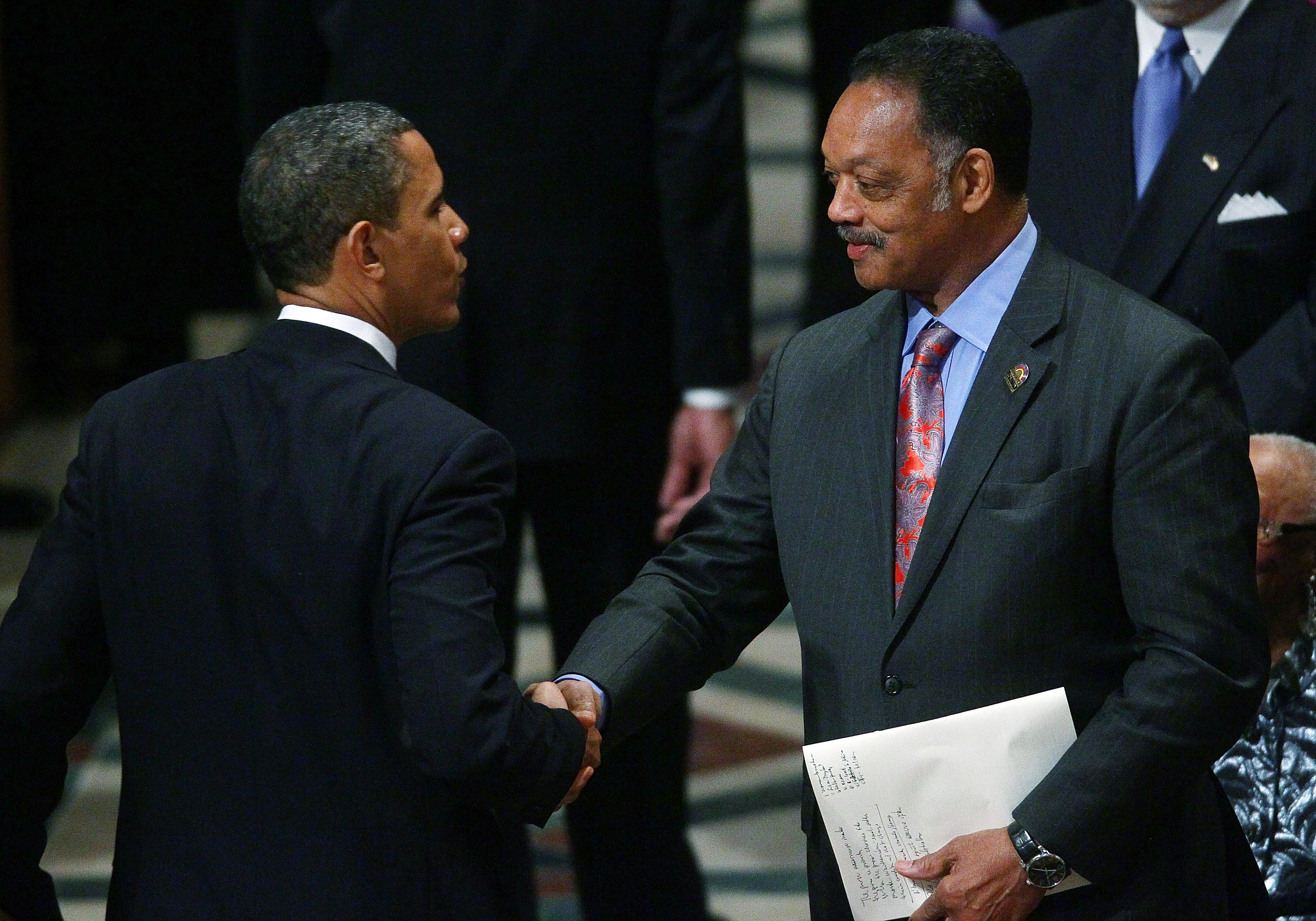 Barack Obama and Jesse Jackson shake hands at the funeral service for civil rights leader Dorothy Height at the Washington National Cathedral in D.C., on April 29, 2010. | Source: Getty Images