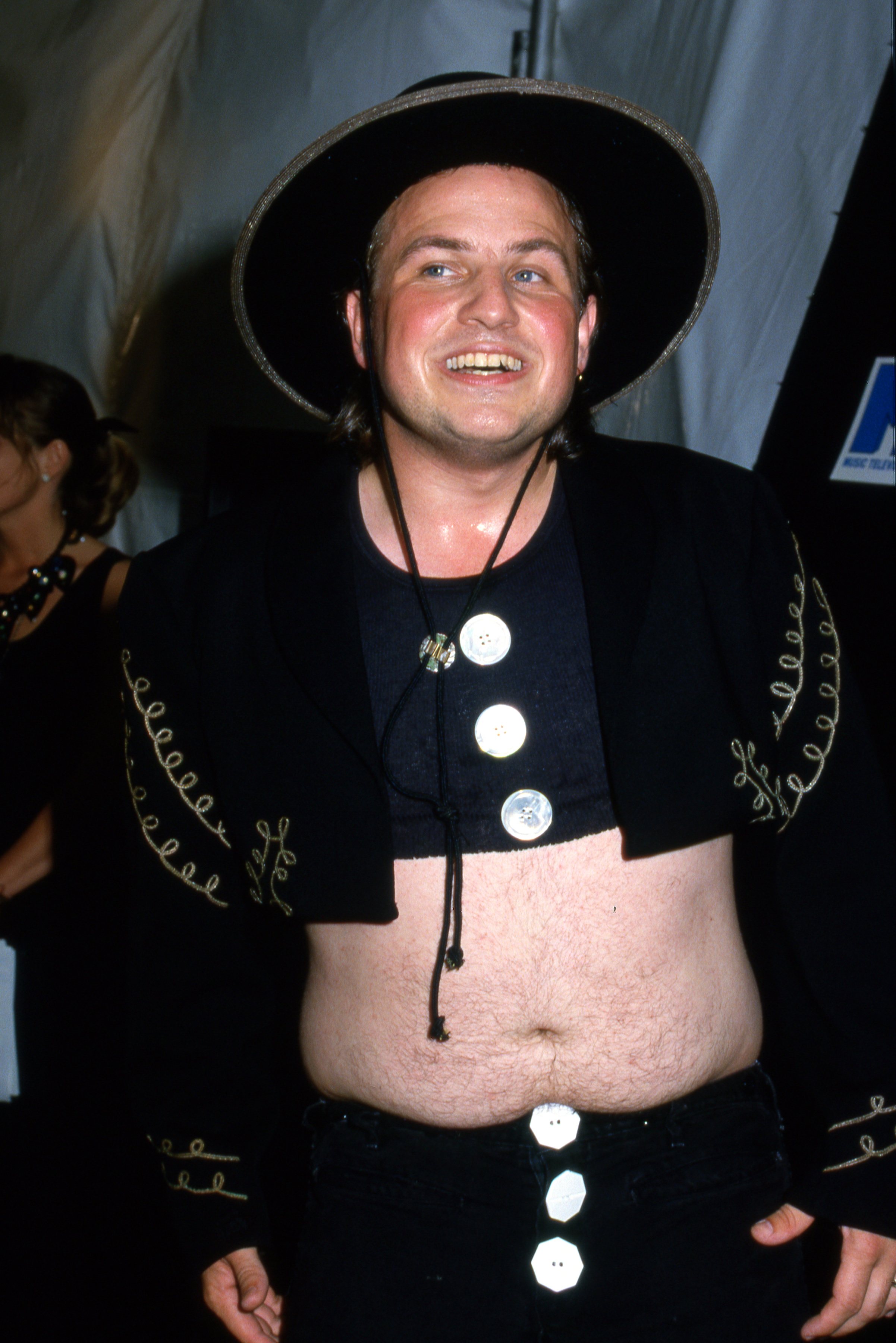 Bobcat Goldthwait strikes a playful pose at the MTV Video Music Awards (VMAs), showing off his eccentric cropped jacket and wide-brimmed hat on music's wildest night.