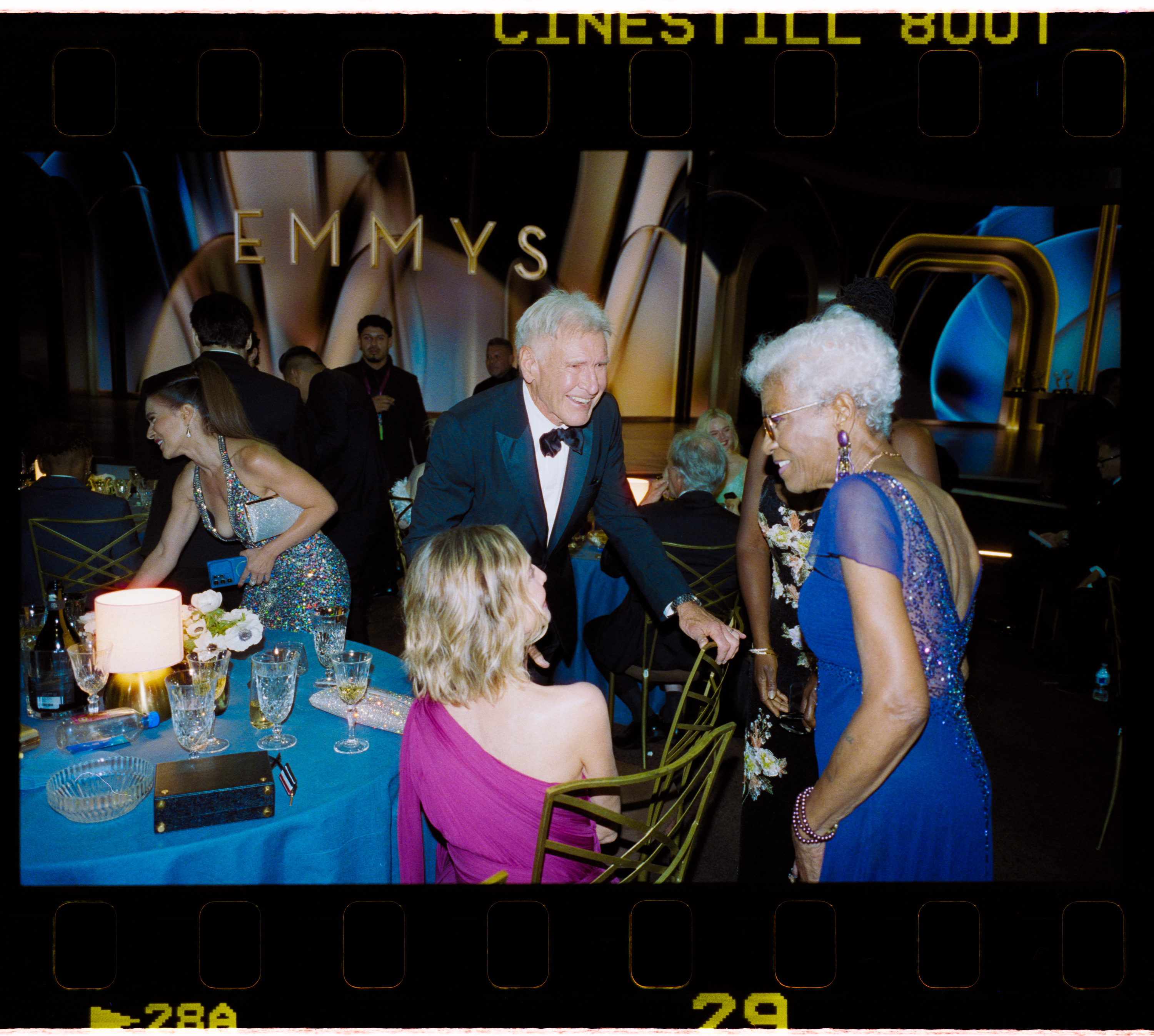 Ford greets another attendee while Flockhart remains seated at their table during the Emmys. The ceremony capped a night that combined professional recognition for Ford with widespread online discussion of the couple's appearance.