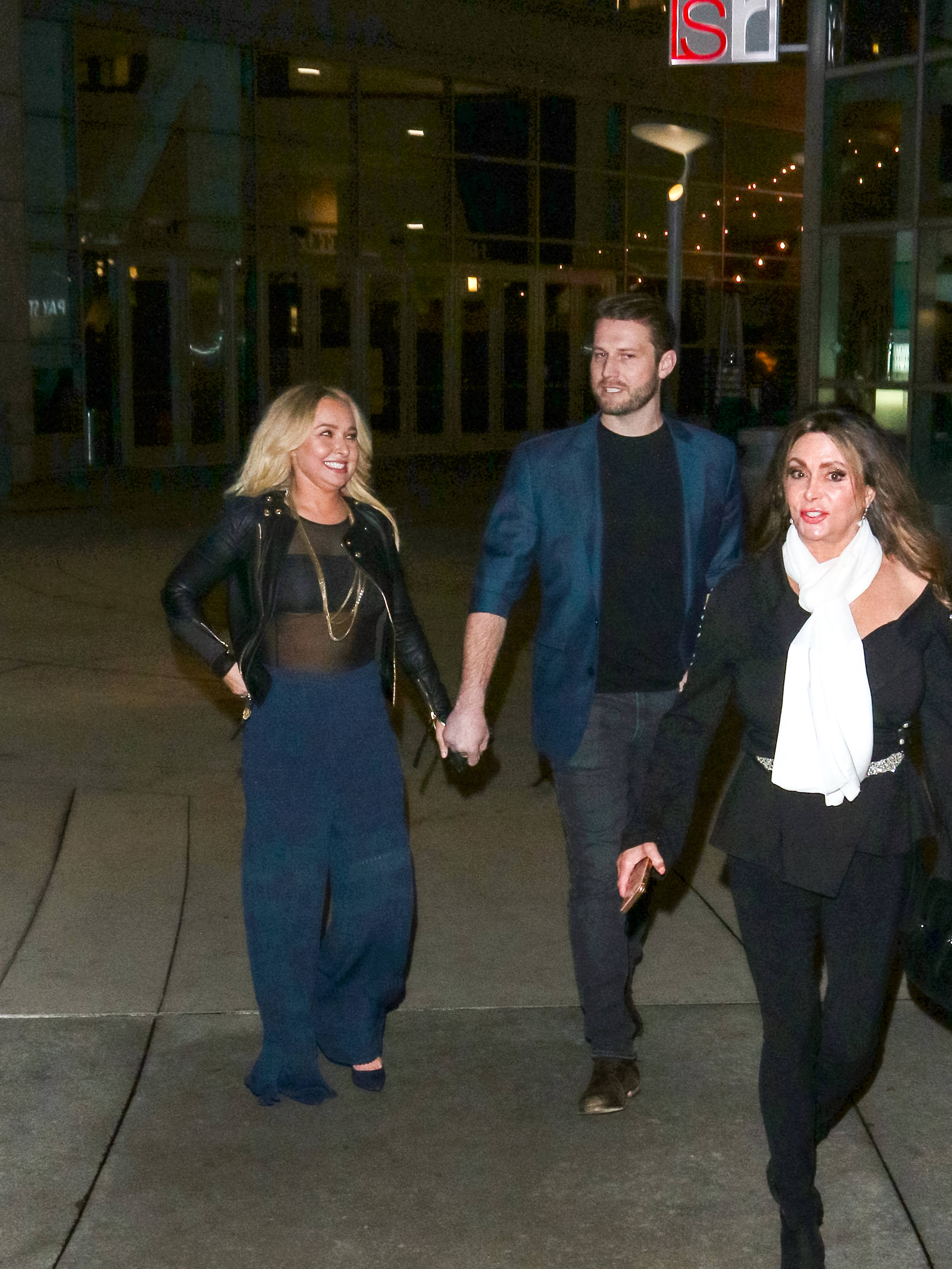 Hayden Panettiere and Brian Hickerson hold hands while walking together in 2019, accompanied by another woman. The couple's relationship later became complicated by Hickerson's legal troubles, with reports revealing they continued communicating despite periods when their romance appeared to have ended publicly. | Source: Getty Images