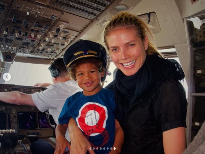 A young Henry beamed in a pilot's cap while he sat in a cockpit beside his smiling mom, Heidi Klum. The joyful moment captured a playful adventure and a mother-son bond in mid-air | Source: Instagram/henrygunthersamuel