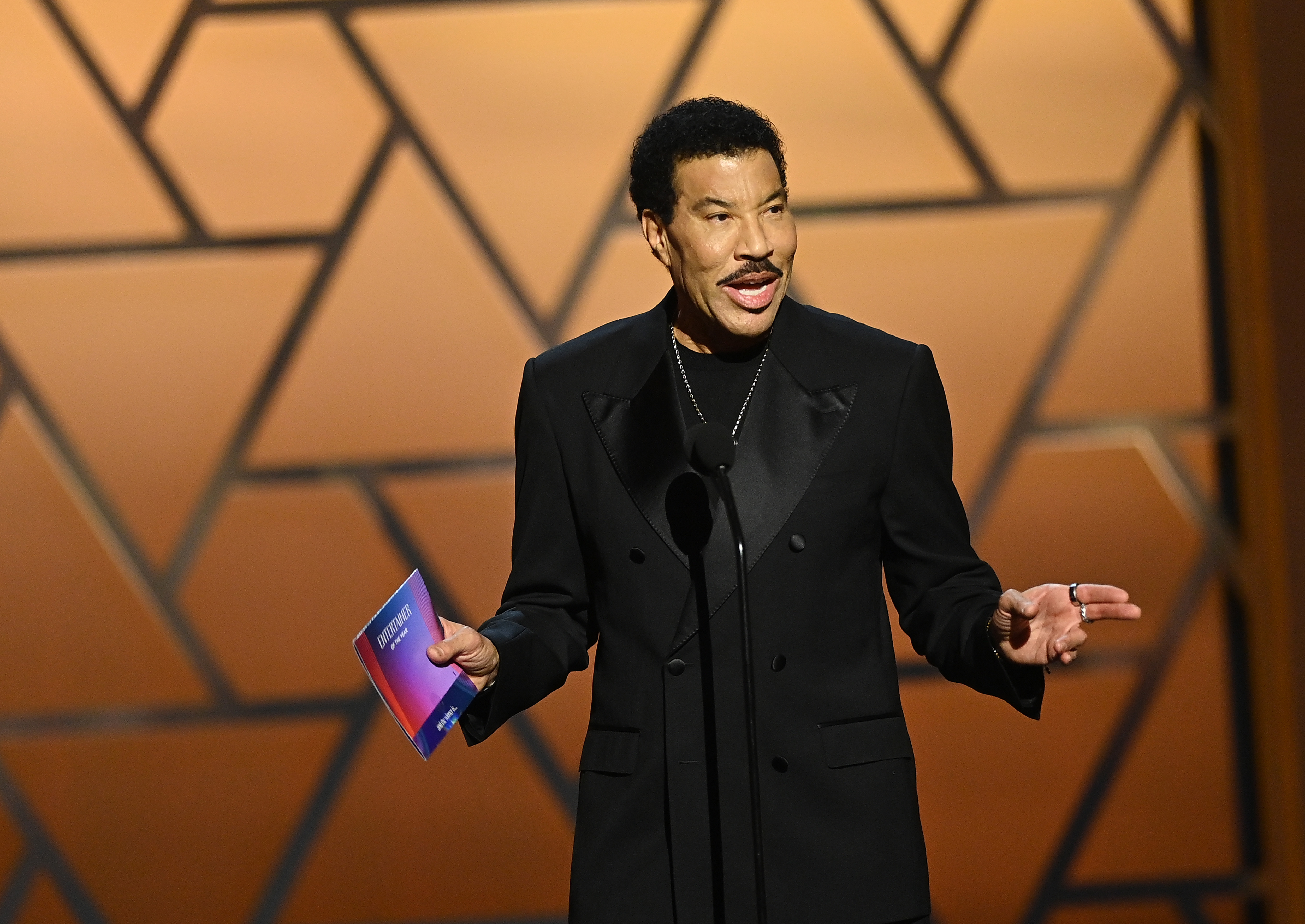 Richie speaks onstage at the NAACP Image Awards in February 2026, months before his first reported health scare of the summer. In June, a concert in St. Paul ended early after he became ill and was taken to a hospital as a precaution. | Source: Getty Images