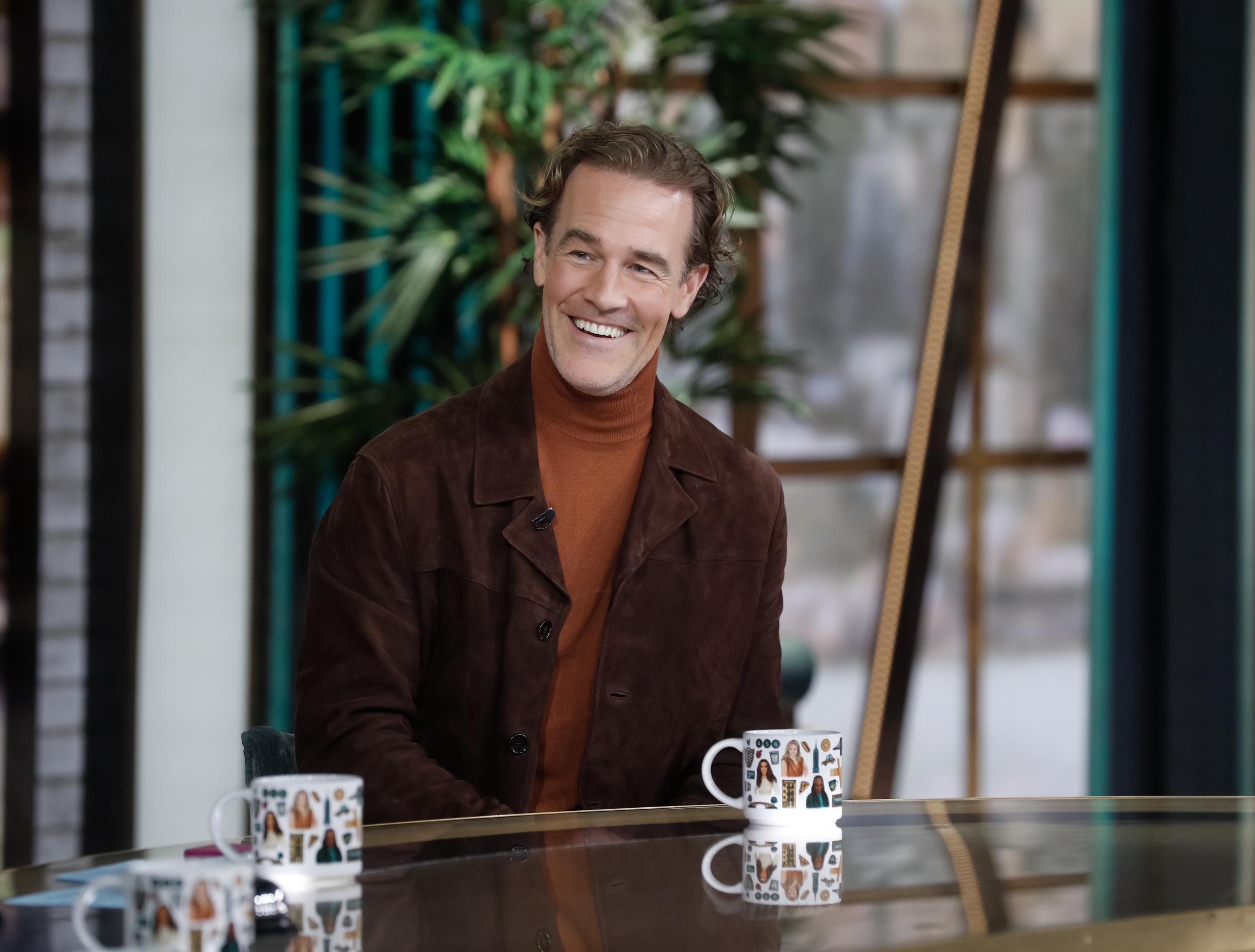 James Van Der Beek sits with easy warmth in a suede jacket and rust turtleneck, his smile lighting up "The View" studio. Relaxed and engaged, he brings calm charisma and thoughtful charm to the conversation.