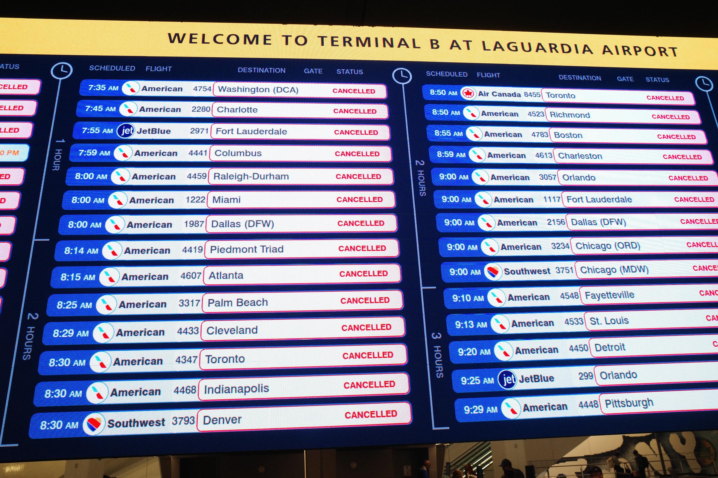 Cancelled flights are displayed on a screen at Terminal B in LaGuardia Airport on March 23, 2026, in New York City | Source: Getty Images