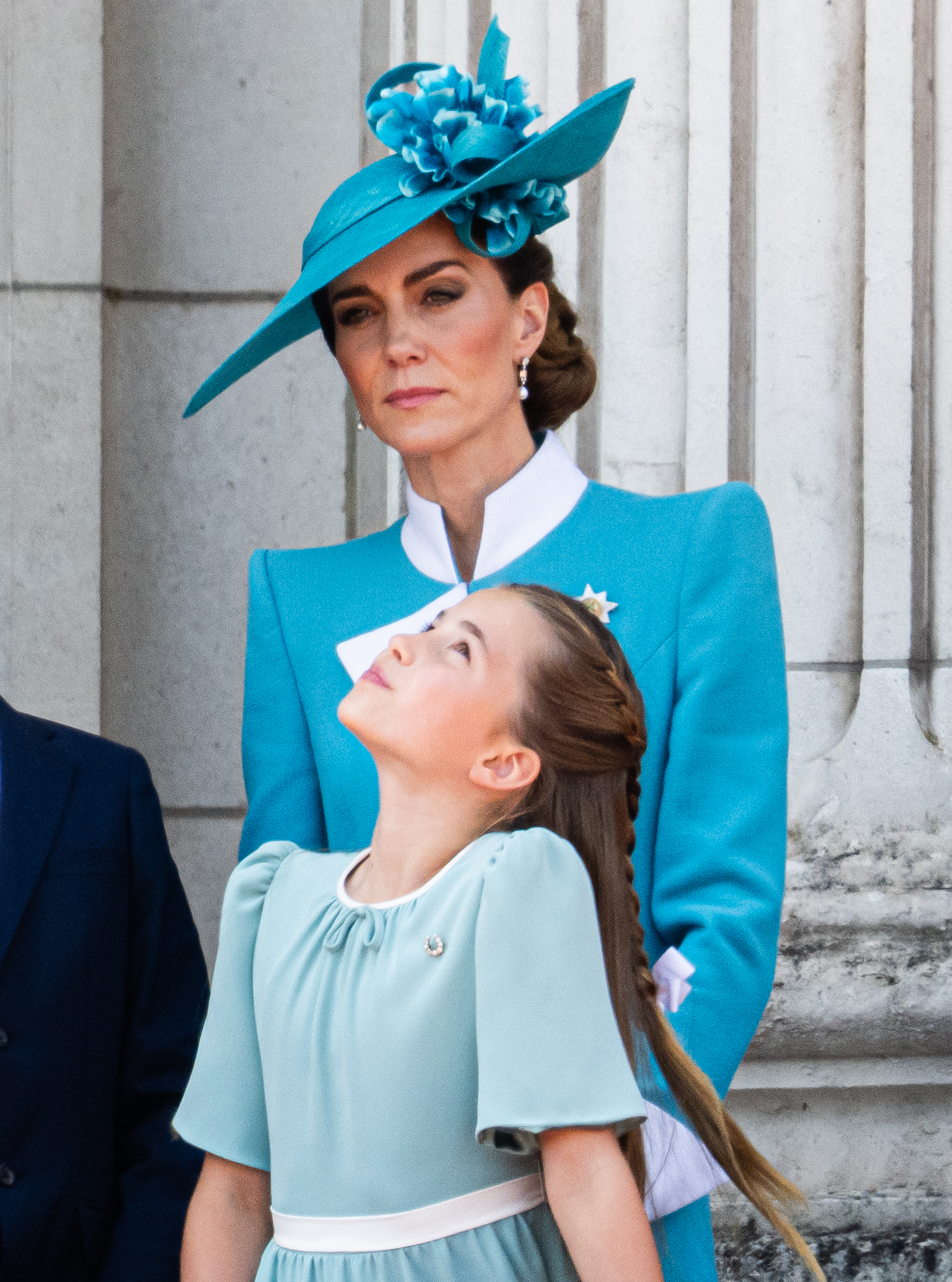 Princes Charlotte looks up at her mother Catherine as they take photos on the Palace balcony during 2025 Trooping The Colour ceremony