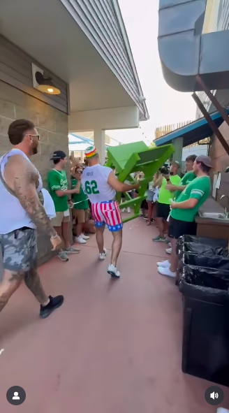 Jason Kelce carrying a green lifeguard chair through the crowd, posted on June 26, 2025. | Source: Instagram/newheightshow