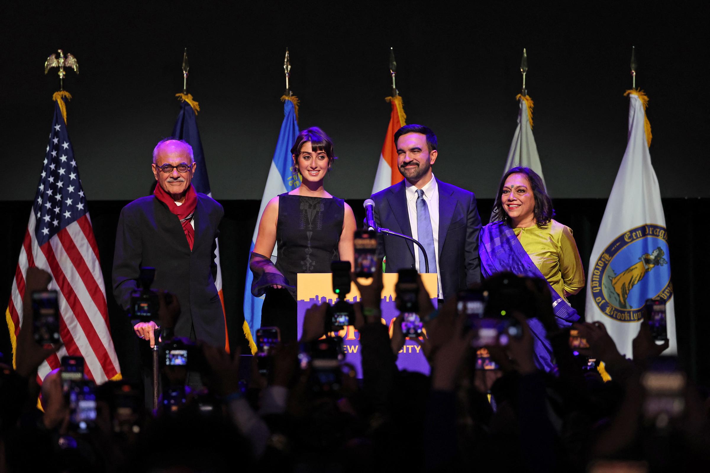 Zohra Mamdani stands at the podium with his wife Rama Duwaji and parents, filmmaker Mira Nair and author Mahmood Mamdani, as they celebrate on election night in Brooklyn on November 4, 2025.