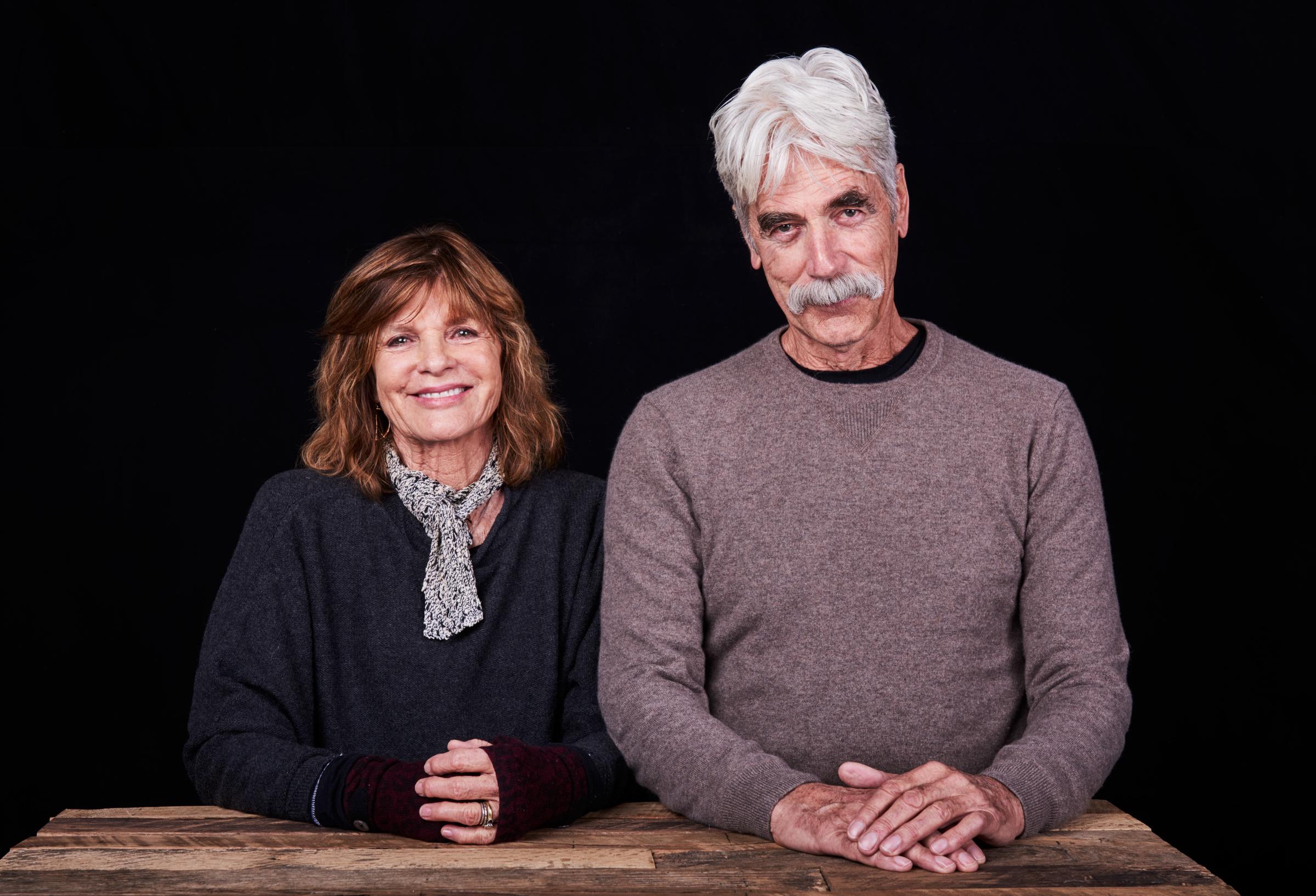 Winter warmth defined Katharine Ross and Sam Elliott's appearance at the Sundance Film Festival on January 22, 2017, in Park City, Utah. Seated side-by-side at a rustic wooden table for a studio portrait, Katharine smiled in a charcoal knit sweater styled with a small patterned neck scarf and fingerless gloves, while Sam matched her understated look in a heather-brown crewneck sweater.