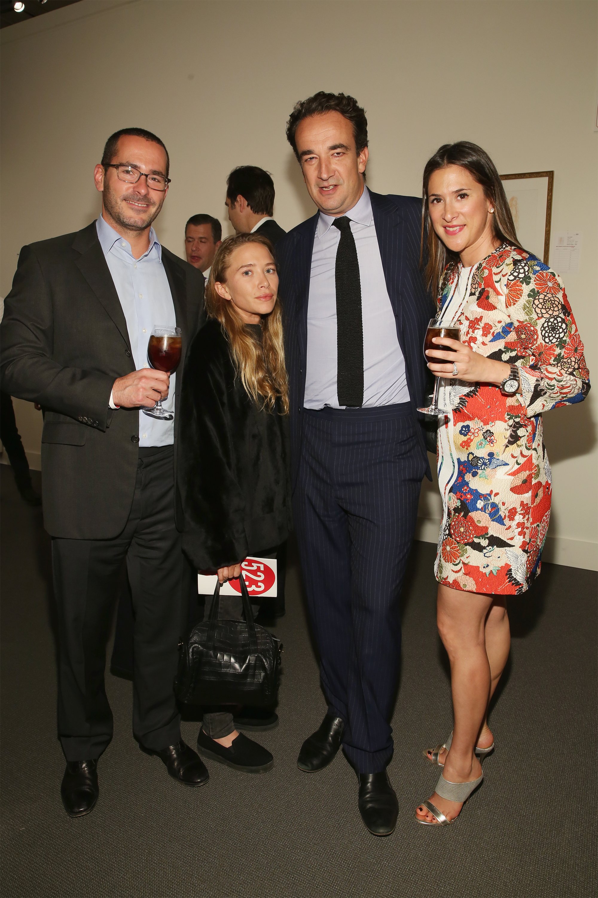 The former actress pictured with Olivier Sarkozy and guests during 2015 Take Home a Nude Art Auction and Party at Sotheby's on October 15, 2015 | Source: Getty Images