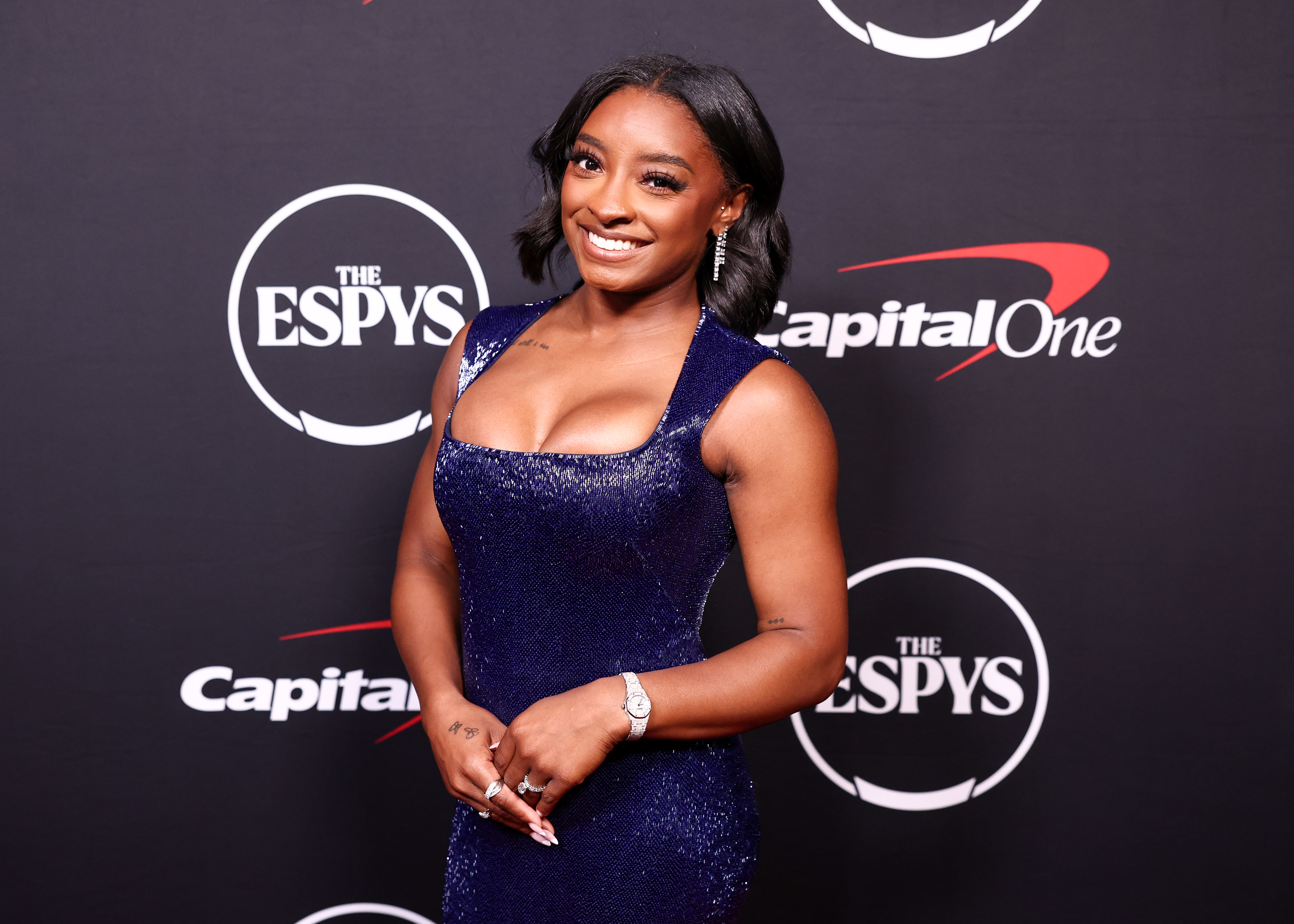 Standing poised with a soft smile, Simone Biles stuns in a figure-hugging sequined gown, her glam look stealing the spotlight at the 2025 ESPYs at the Dolby Theatre.