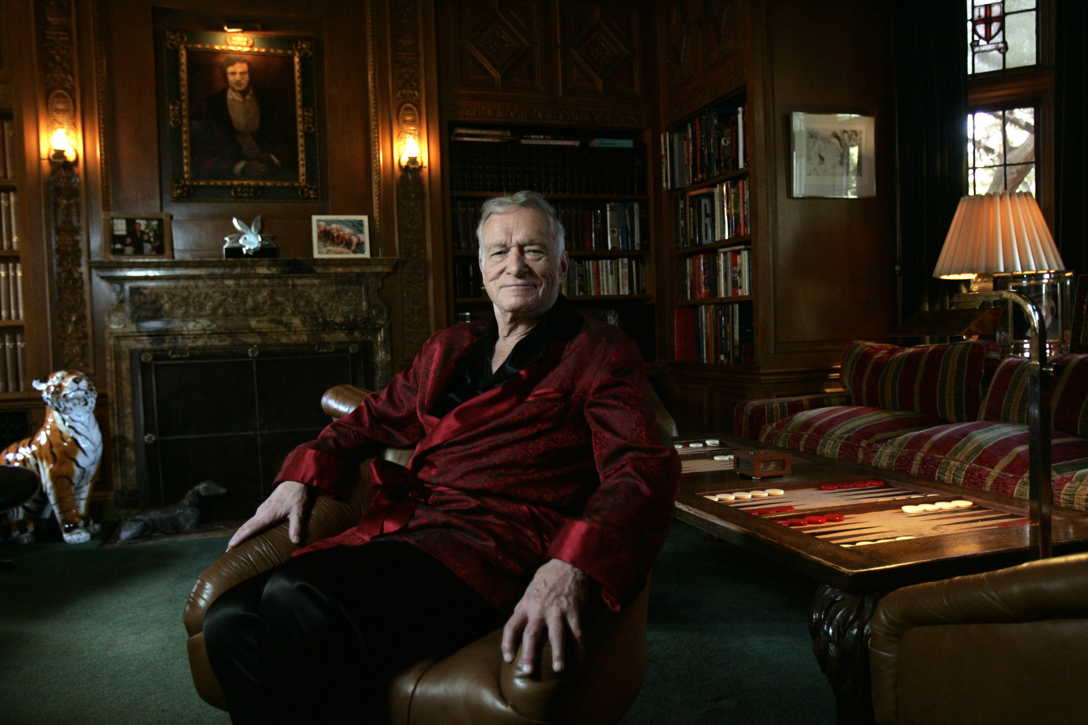 Playboy founder Hugh Hefner sits inside his Los Angeles mansion on February 26, 2009. Actor Bill Pullman portrays the late magazine publisher in "Playmates," which follows an aspiring Playmate and a teenage girl who form an unlikely friendship. | Source: Getty Images