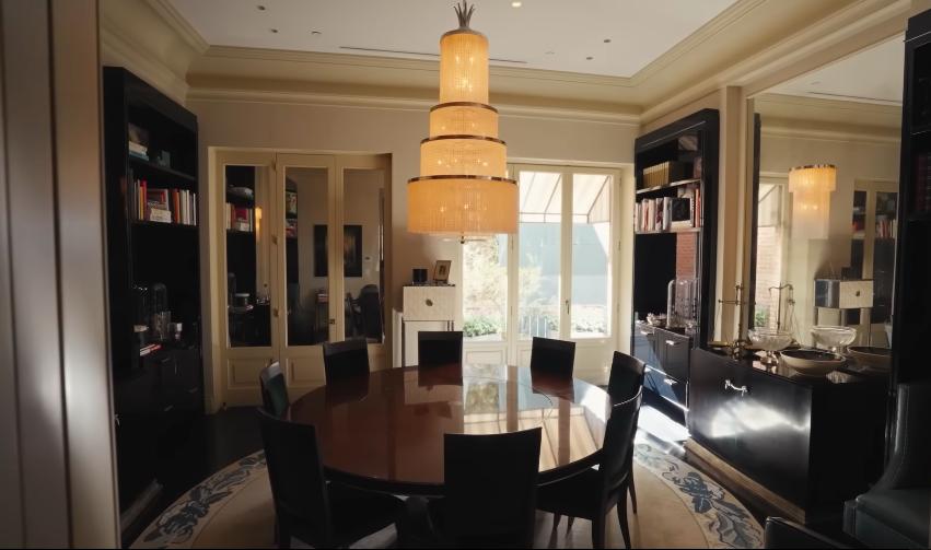 The dining room reflects the couple's love of Deco drama without losing the feeling of a real family home. Many of the home's crystal chandeliers, decorative objects, and Art Deco pieces were found during a Paris shopping trip with Sofield. | Source: YouTube/Architectural Digest