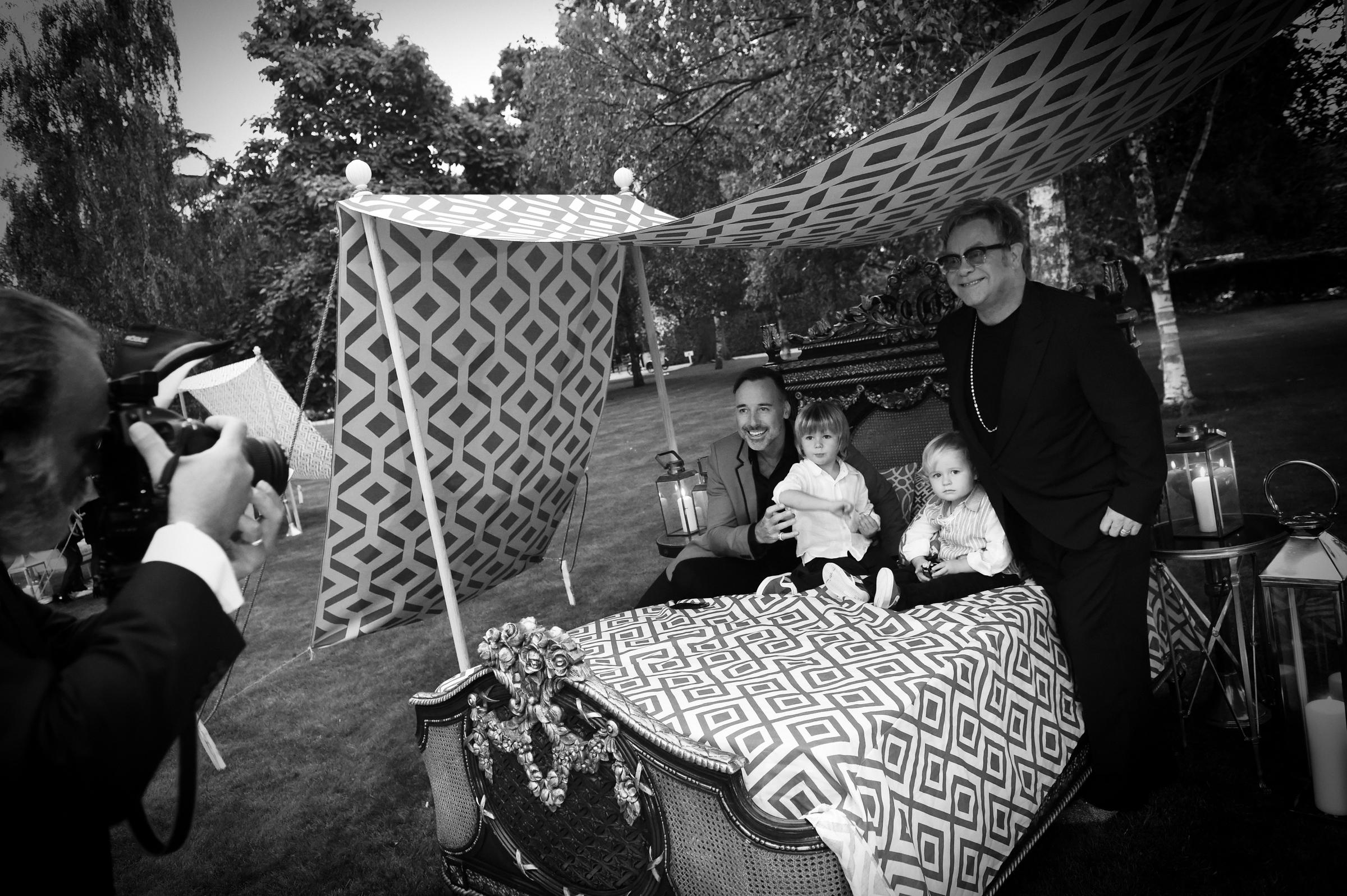 David Furnish and Elton John with their sons during the Woodside End of Summer party on September 4, 2014, in Windsor, England. | Source: Getty Images