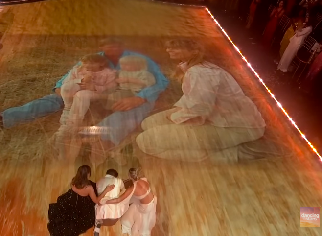 Bindi Irwin and Witney Carson comforting Robert Irwin as he breaks down emotionally while watching archival footage of his dad and family. | Source: YouTube/Dancing With The Stars