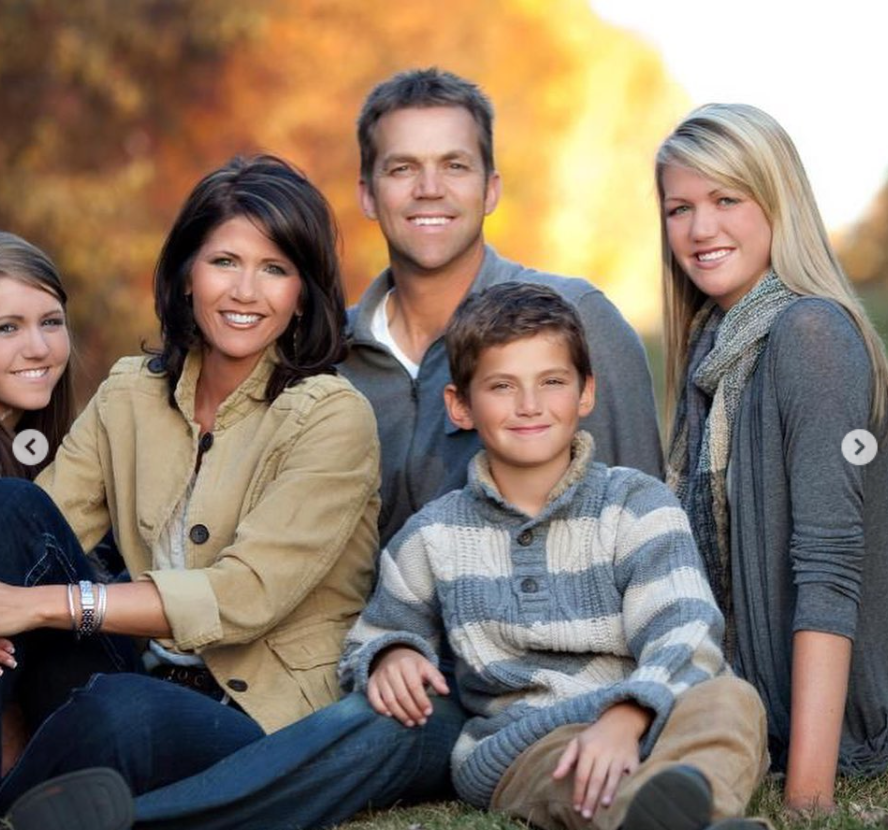 Seated together in a family-style portrait, Kristi and Bryon appear relaxed and approachable — anchoring the image with calm, steady expressions. | Source: Instagram/sdbryonnoem
