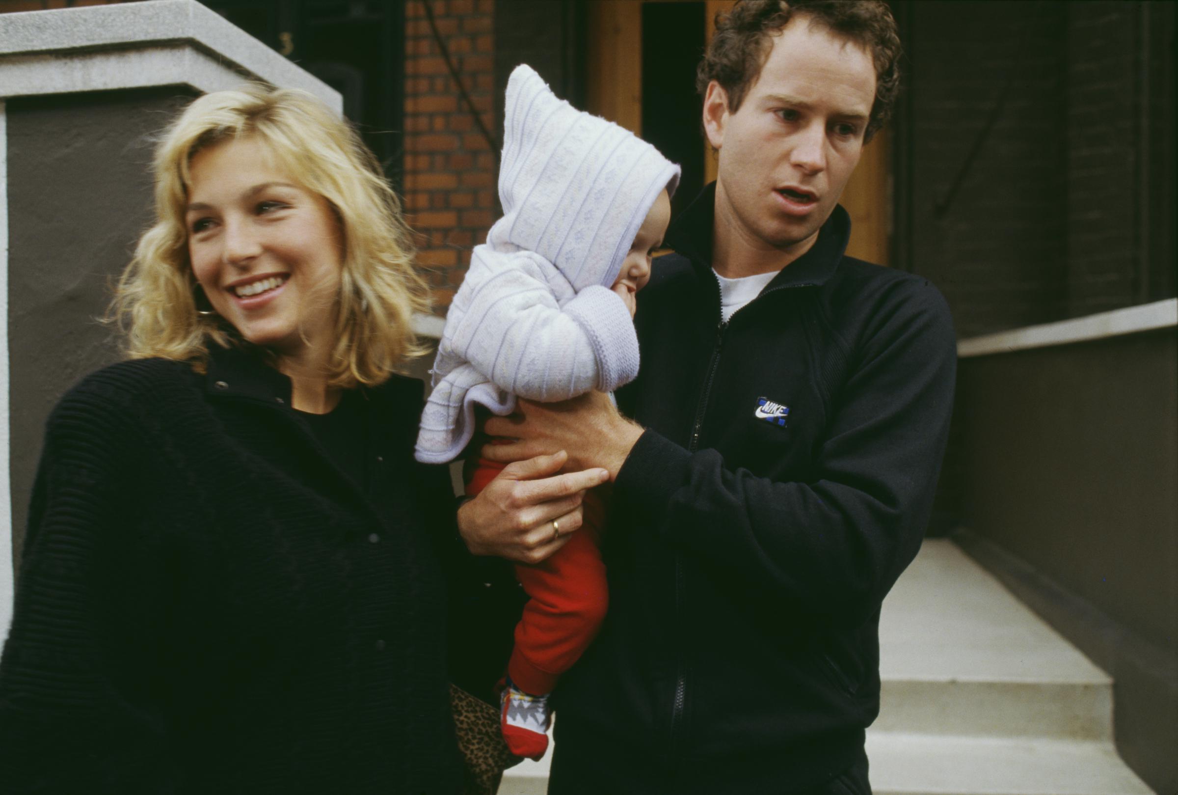Tatum O'Neal and John McEnroe were photographed with one of their children around 1987. The couple had married in August 1986 at St. Dominic's Catholic Church in Oyster Bay, New York, shortly after welcoming their first child, Kevin. | Source: Getty Images.