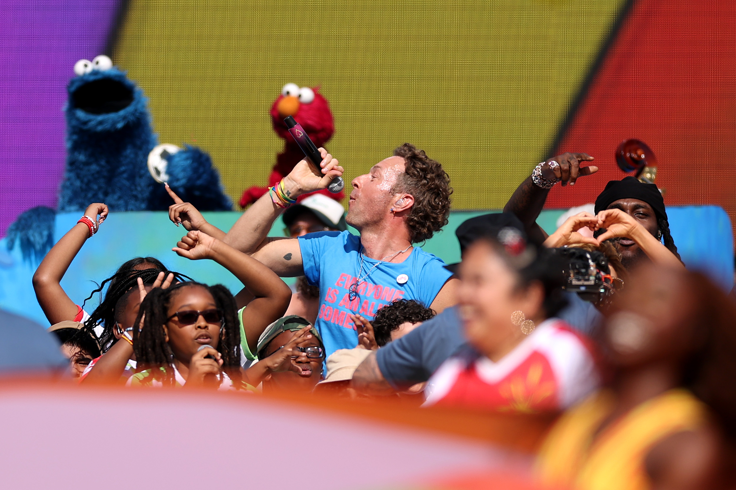 Chris Martin's role extended beyond curating the halftime show's musical lineup. The production also incorporated Global Citizen's education campaign, with appearances by Sesame Street characters and children helping reinforce the event's broader message. | Source: Getty Images
