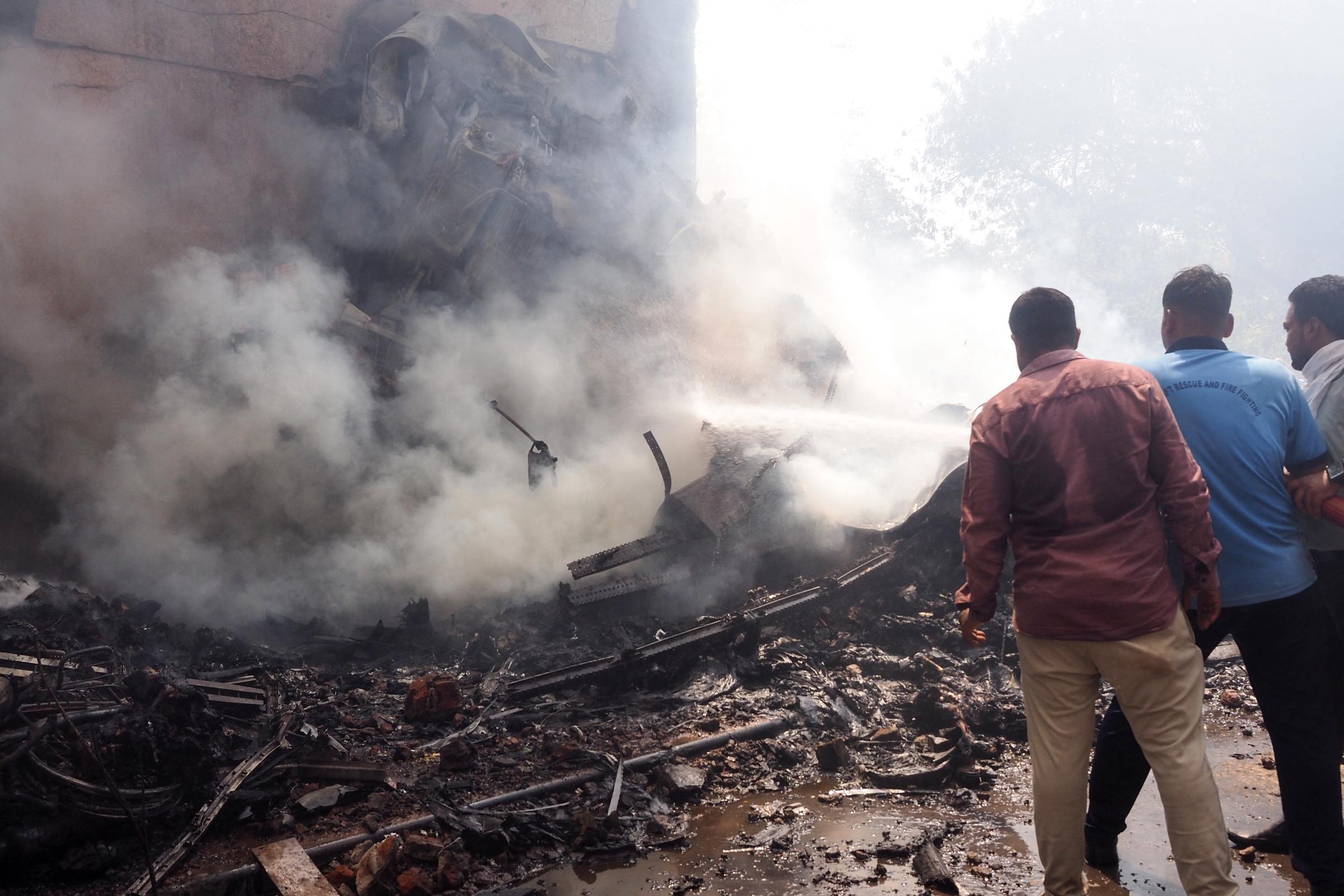 Firefighters work at the site where Air India flight 171 crashed in a residential area on June 12, 2025, in Ahmedabad, India. | Source: Getty Images