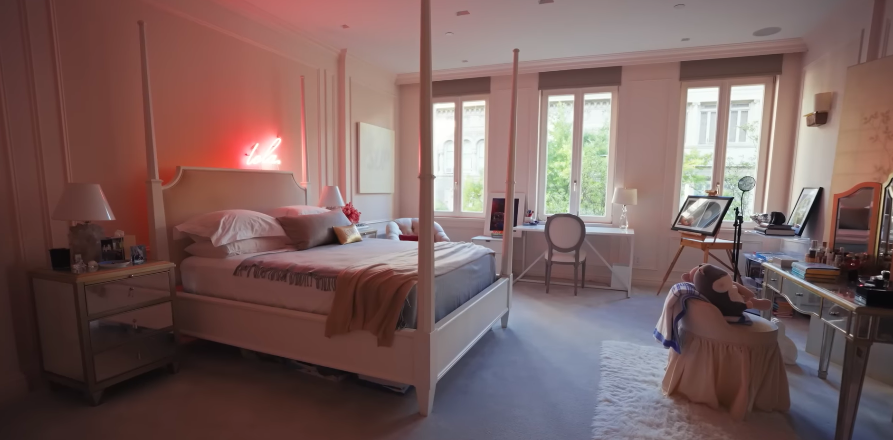 The glowing name sign gives the room a sweet, custom touch. In a house filled with antiques and Deco pieces, this space feels more playful and modern. | Source: YouTube/Architectural Digest