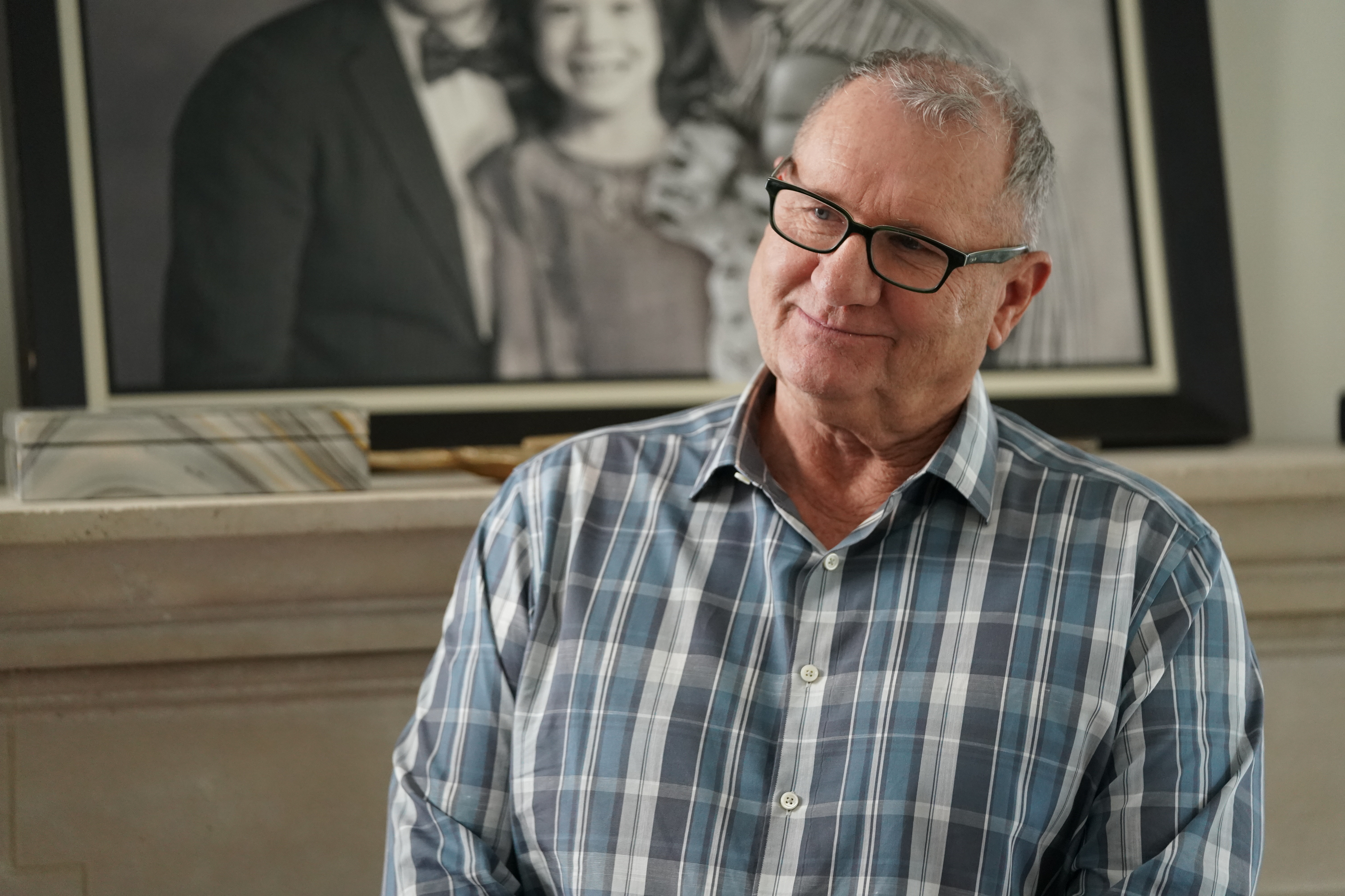 Ed O'Neill shared a tender, reflective moment as family patriarch Jay Pritchett in a scene from the two-part series finale of the long-running ABC comedy series "Modern Family," which aired on April 8, 2020. Sporting a blue-and-grey plaid button-down and black rectangular glasses, the Emmy-nominated actor stood before the living room mantel and framed family portrait as the ensemble cast prepared to close out eleven landmark seasons. | Source: Getty Images