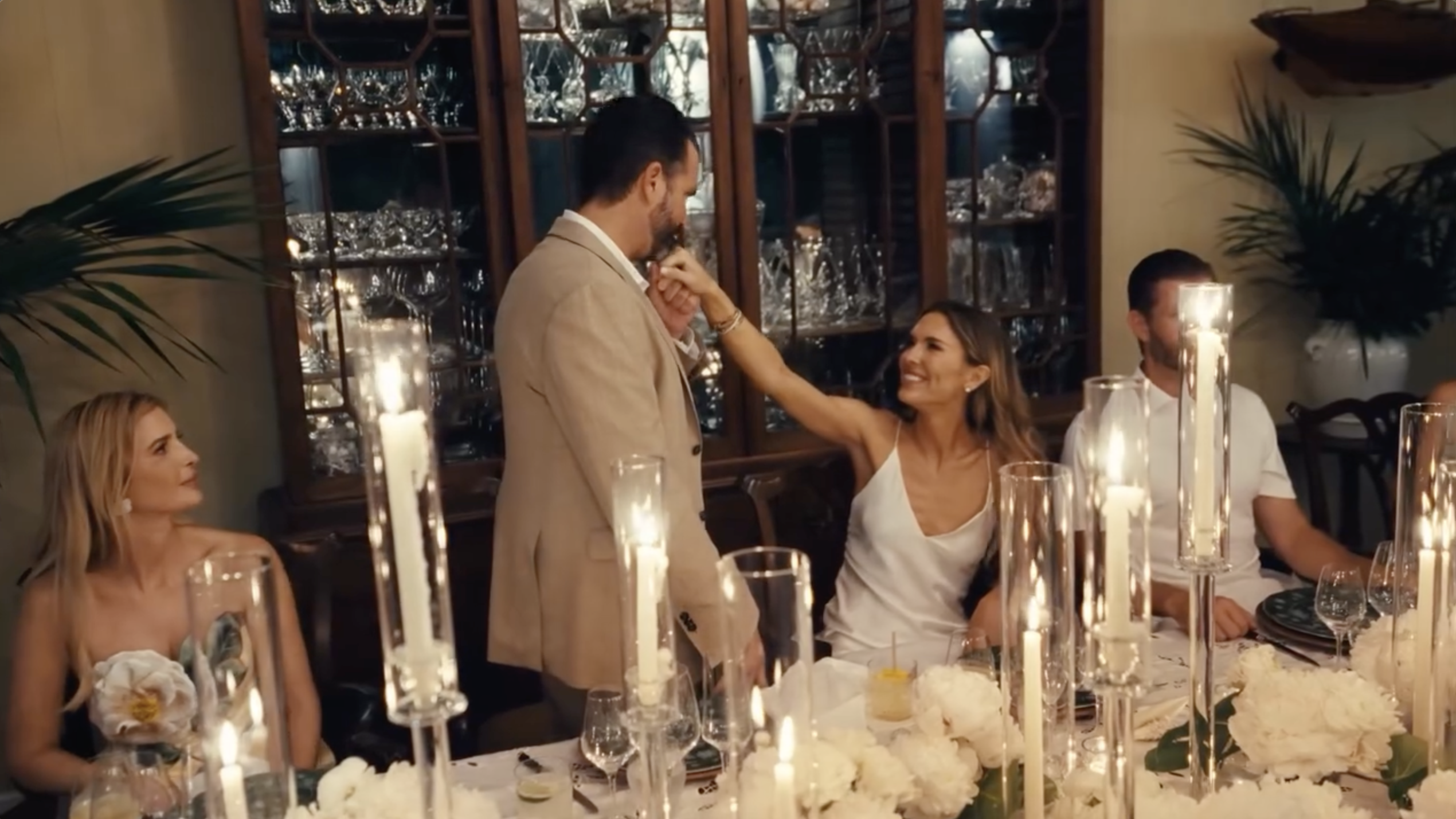Bettina Anderson reaches for Donald Trump Jr. during a candlelit reception moment shared with guests around the table. | Source: Instagram/donaldjtrumpjr