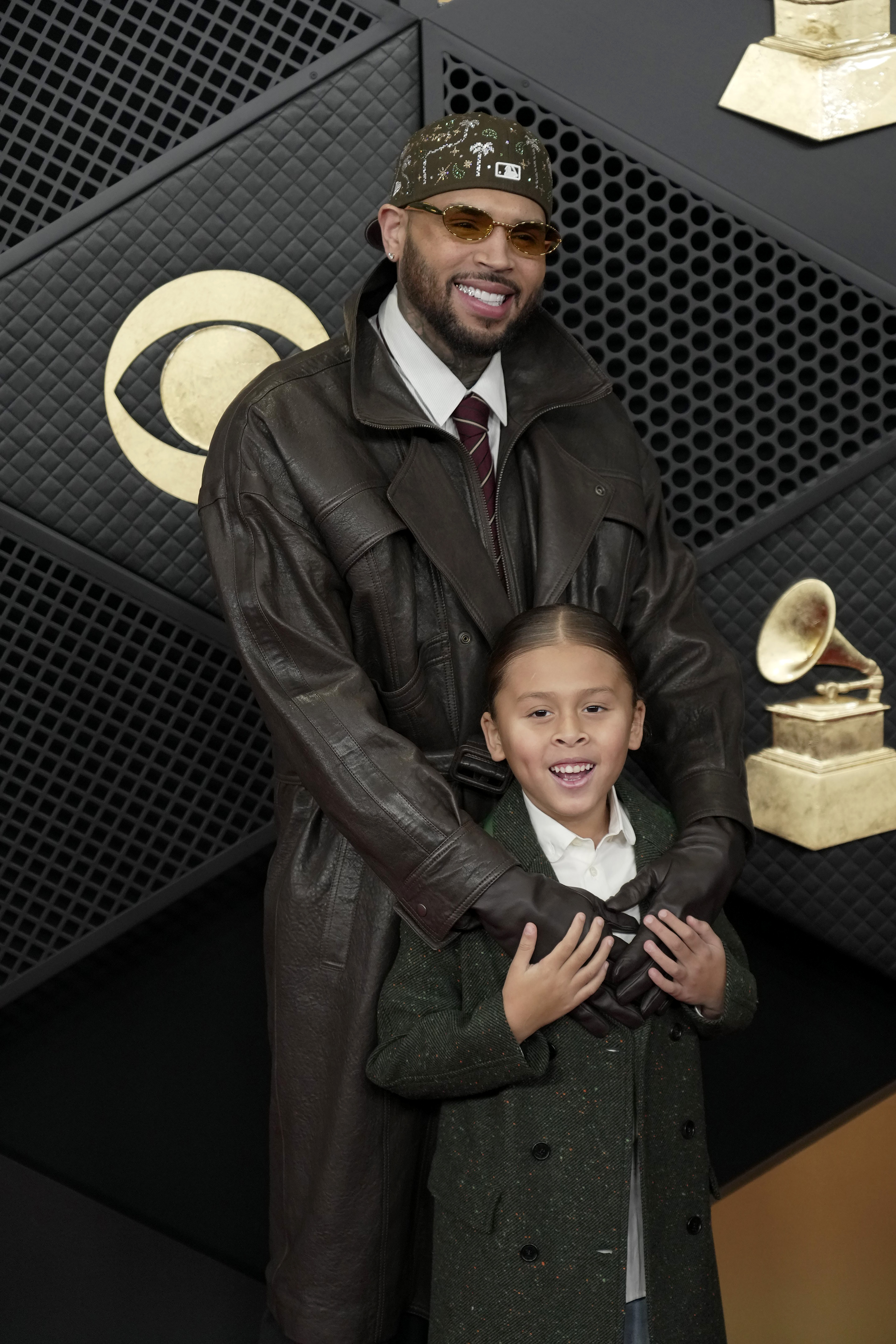 Chris and Aeko Brown sharing a cute father-son moment on the red carpet at this year's GRAMMYs. | Source: Getty Images