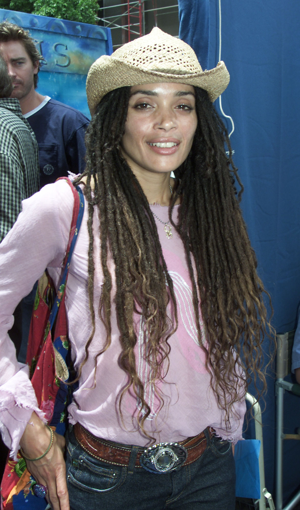 Lisa Bonet arrives at the premiere of Disney's "Atlantis: The Lost Empire" at the El Capitan Theatre, wearing long dreadlocks and a casual hat that reflect her signature free-spirited style.