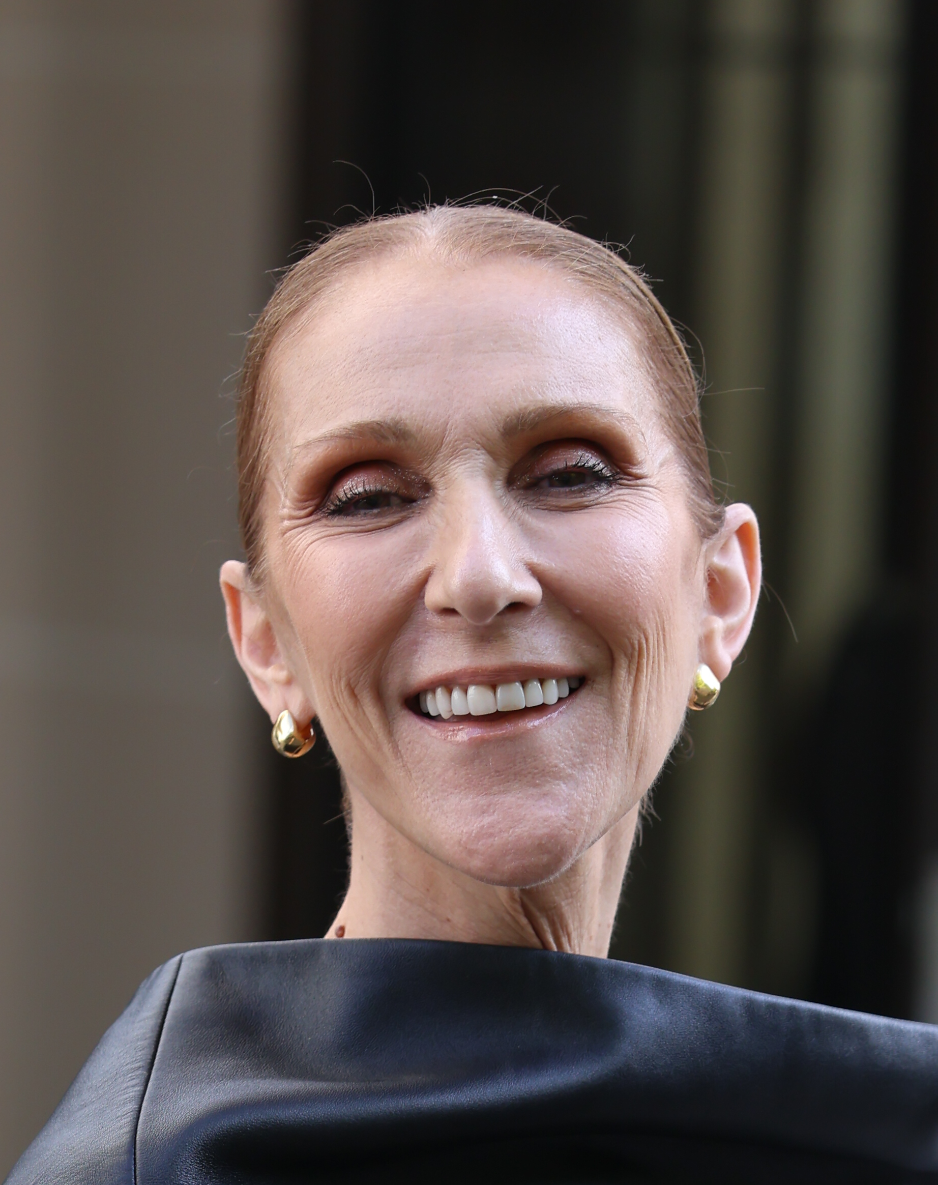 Dion smiles during an outing in Paris on September 1, 2026. Weeks later, she returned to the spotlight at Le Défilé L'Oréal Paris, this time wearing her blonde hair loose around her shoulders. | Source: Getty Images