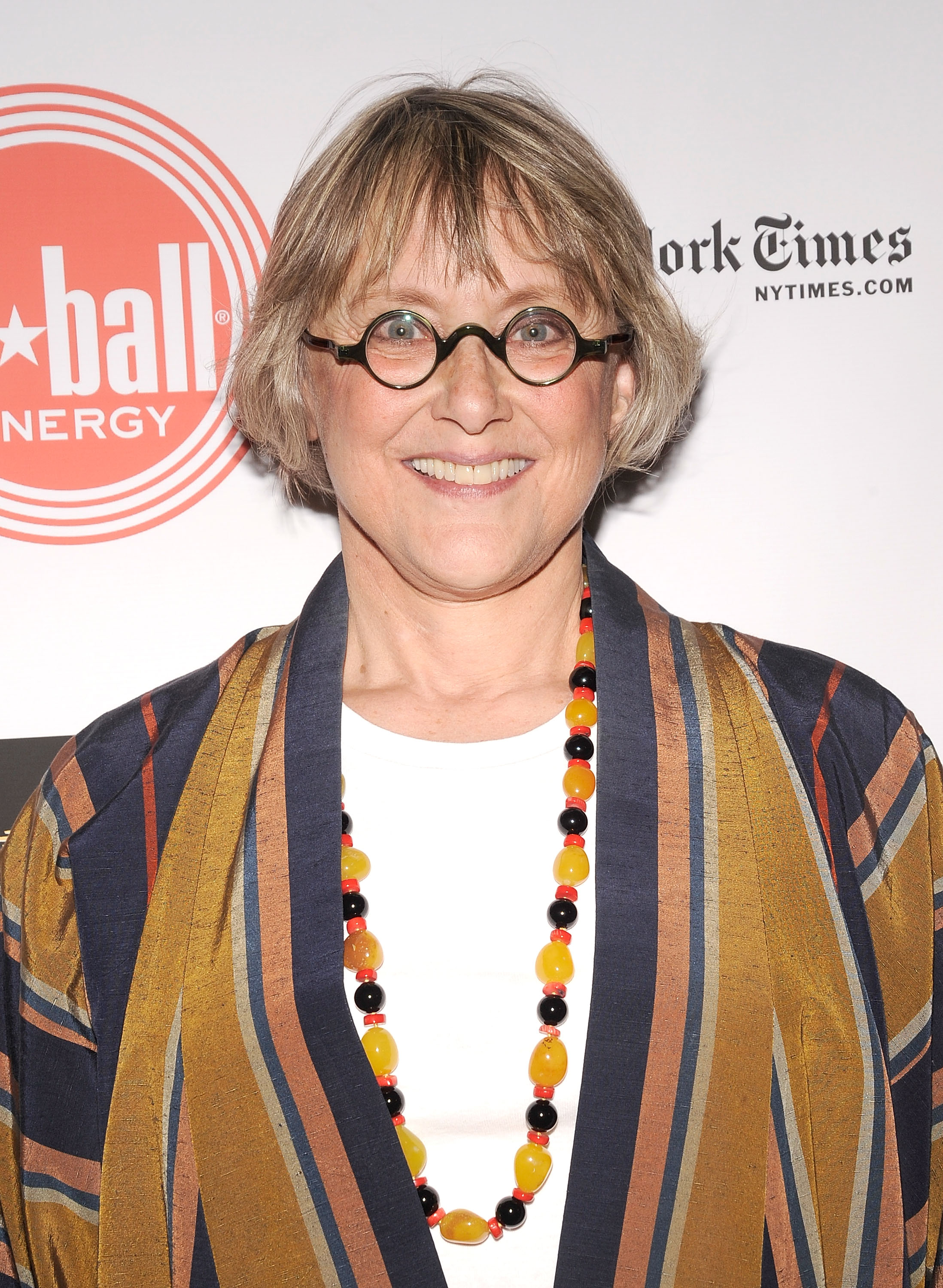 Mary Beth Hurt attends the 2010 Drama Desk Award nominees reception in New York City wearing a striped jacket, white top, and beaded necklace. Her bright smile and round glasses gave the look a lively, artistic feel.