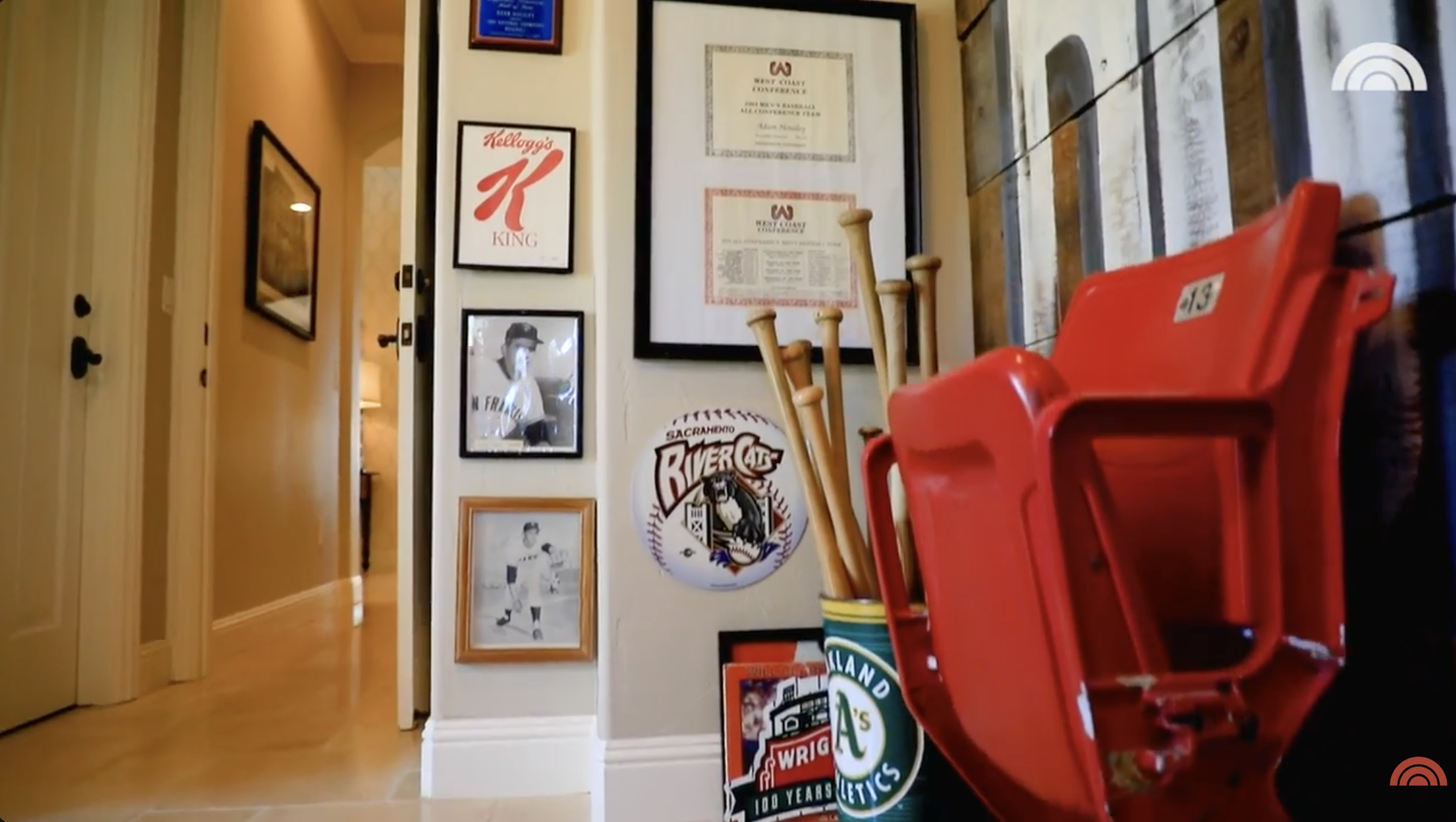 Another view of Adam Housley's man cave, including photos on the wall and baseball bats placed in the corner. | Source: YouTube/Today