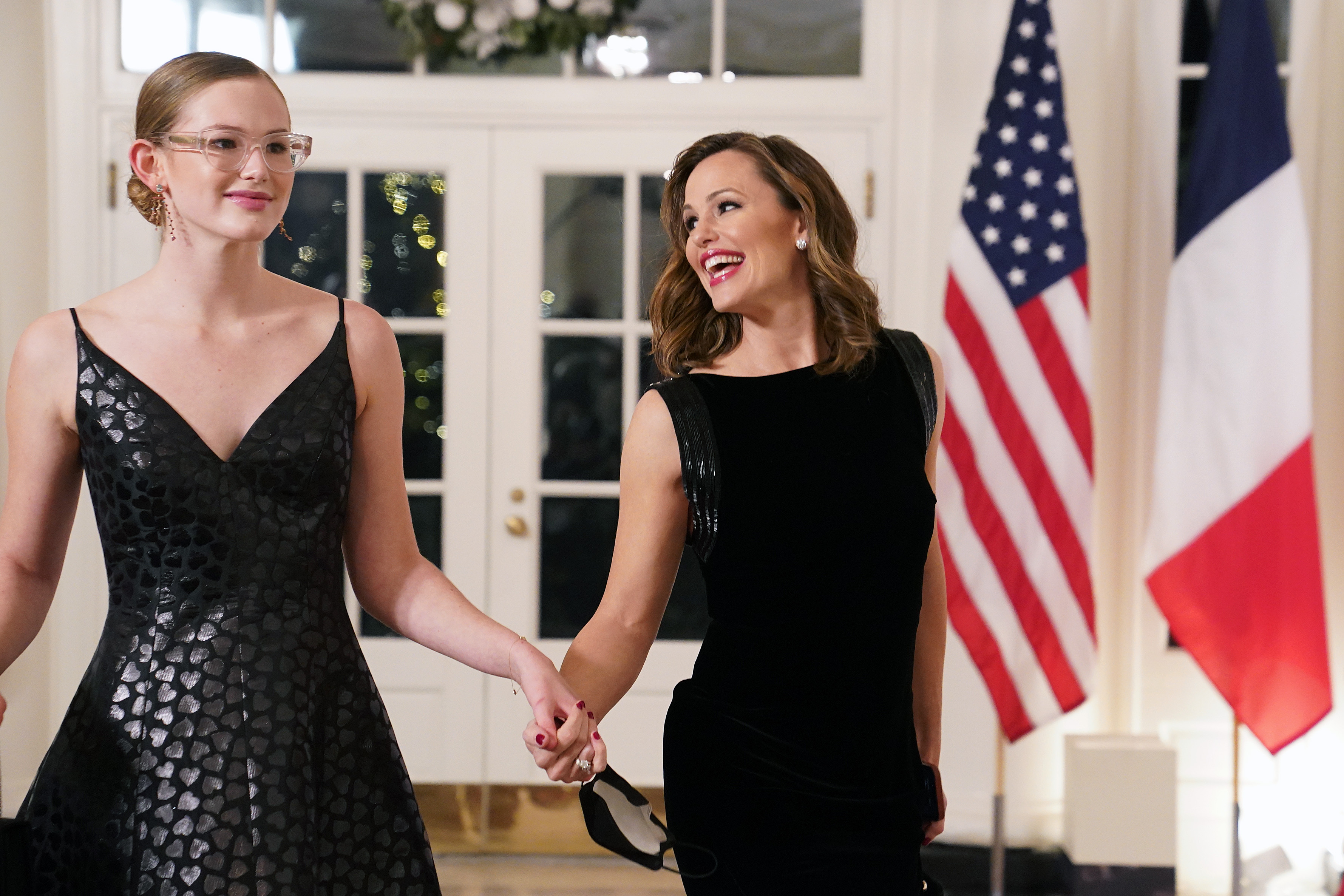 Jennifer Garner smiles at daughter Violet Affleck during a White House state dinner in December 2022. The actress has said she tried to instill a love of reading in her children, while Violet has since emerged as a public health advocate and Yale University student. | Source: Getty Images