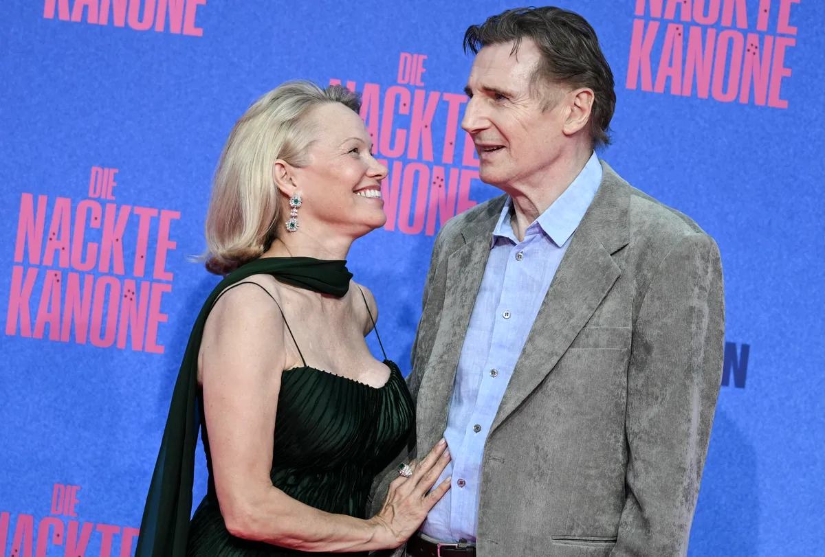 Pamela Anderson looking lovingly at Liam Neeson during the German premiere of "The Naked Gun" on July 24, 2025 in Berlin, Germany.