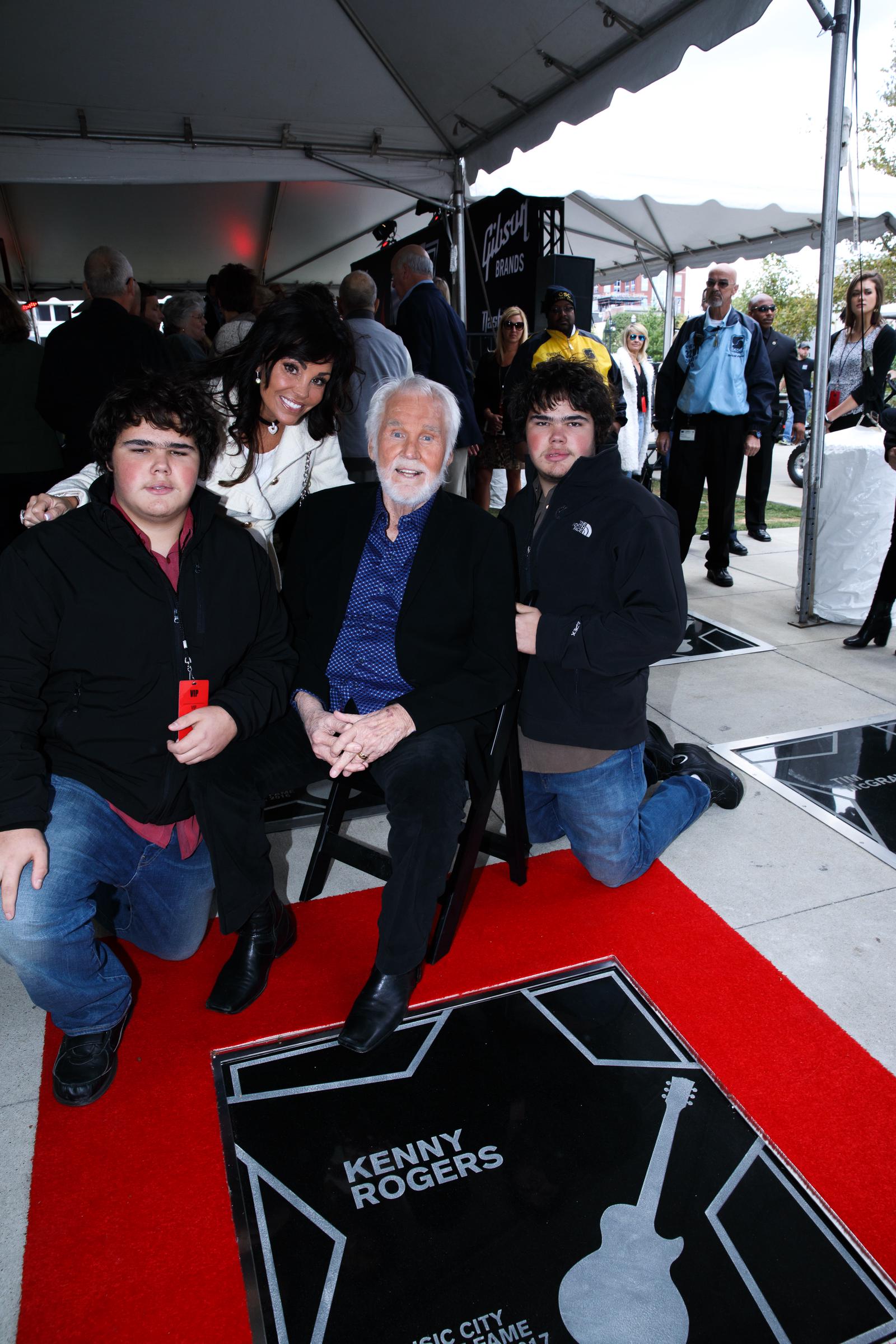 This earlier family photo shows Justin and Jordan Rogers posing alongside their parents, Kenny Rogers and Wanda Miller, offering another point of comparison as fans debate whether the twins have grown to resemble their famous father. | Source: Getty Images