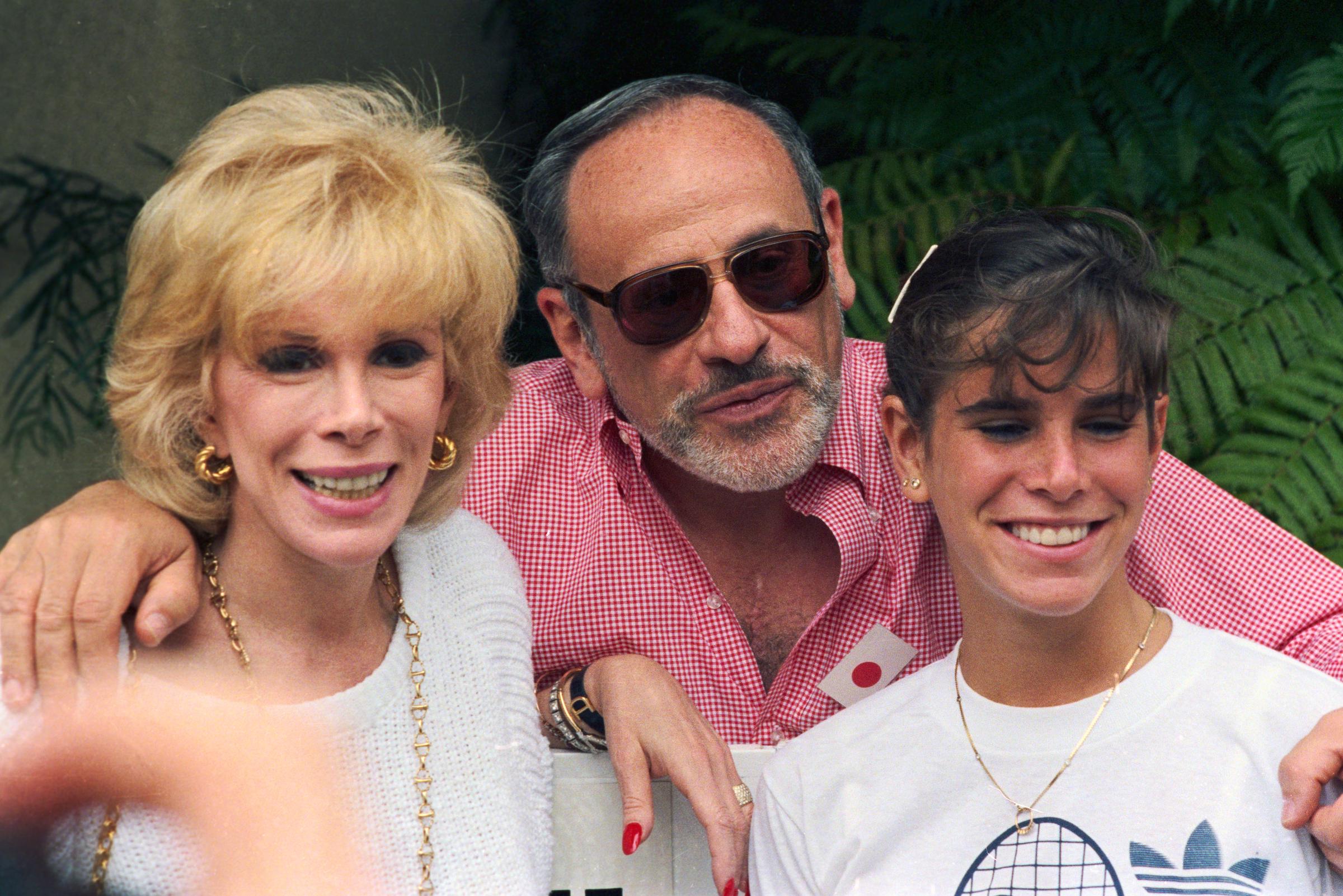 Joan Rivers poses with her husband, Edgar, and daughter, Melissa, at the Joan Rivers Celebrity Tennis-Auction Classic. | Source: Getty Images