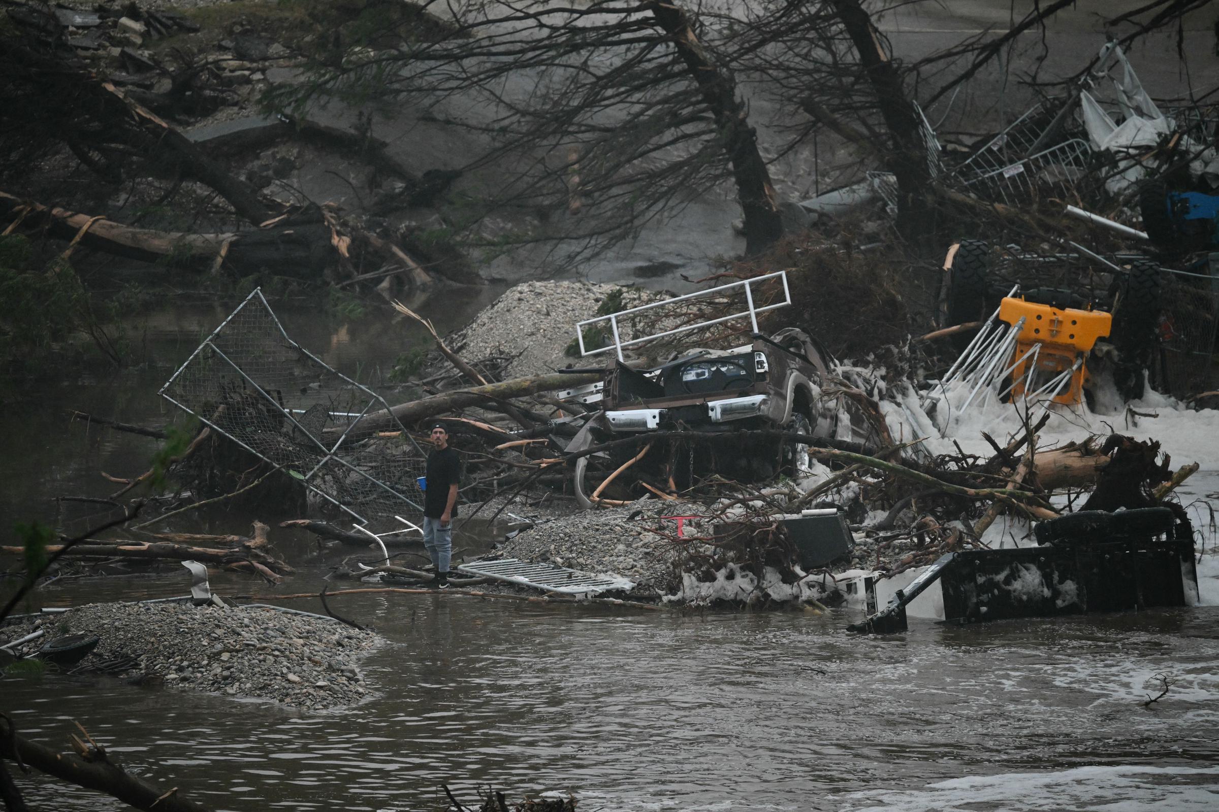 A civilian standing amid the catastrophic damage and debris after the flooding in Kerrville, Texas on July 5, 2025. | Source: Getty Images