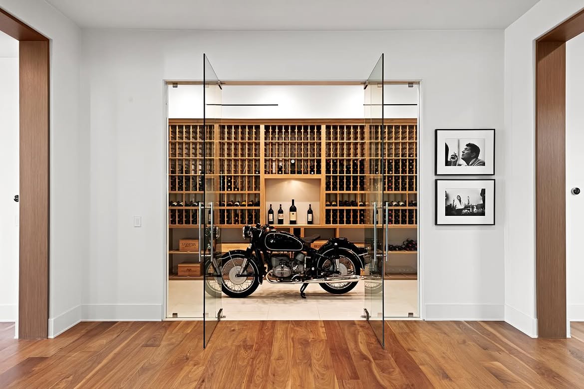 A vintage-style motorcycle turns the wine room into more than a place for bottle storage. Positioned directly in front of the floor-to-ceiling racks, it creates an unexpected focal point that can be seen from the adjoining dining area. | Source: Instagram/theshevins