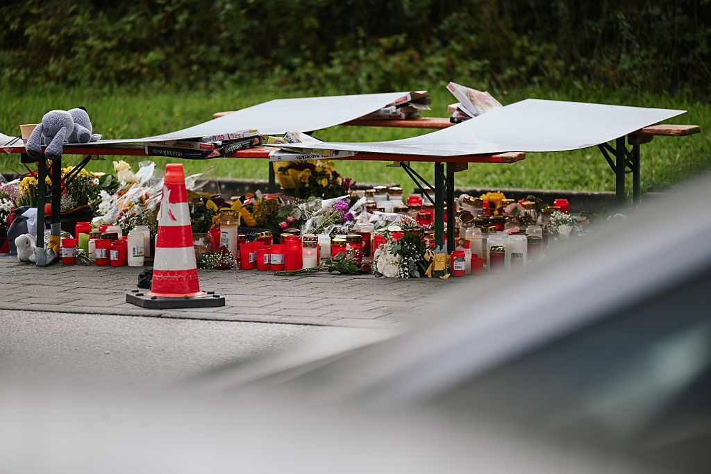 The grieving community places candles, flowers and stuffed animals to commemorate the deceased | Source: Getty Images