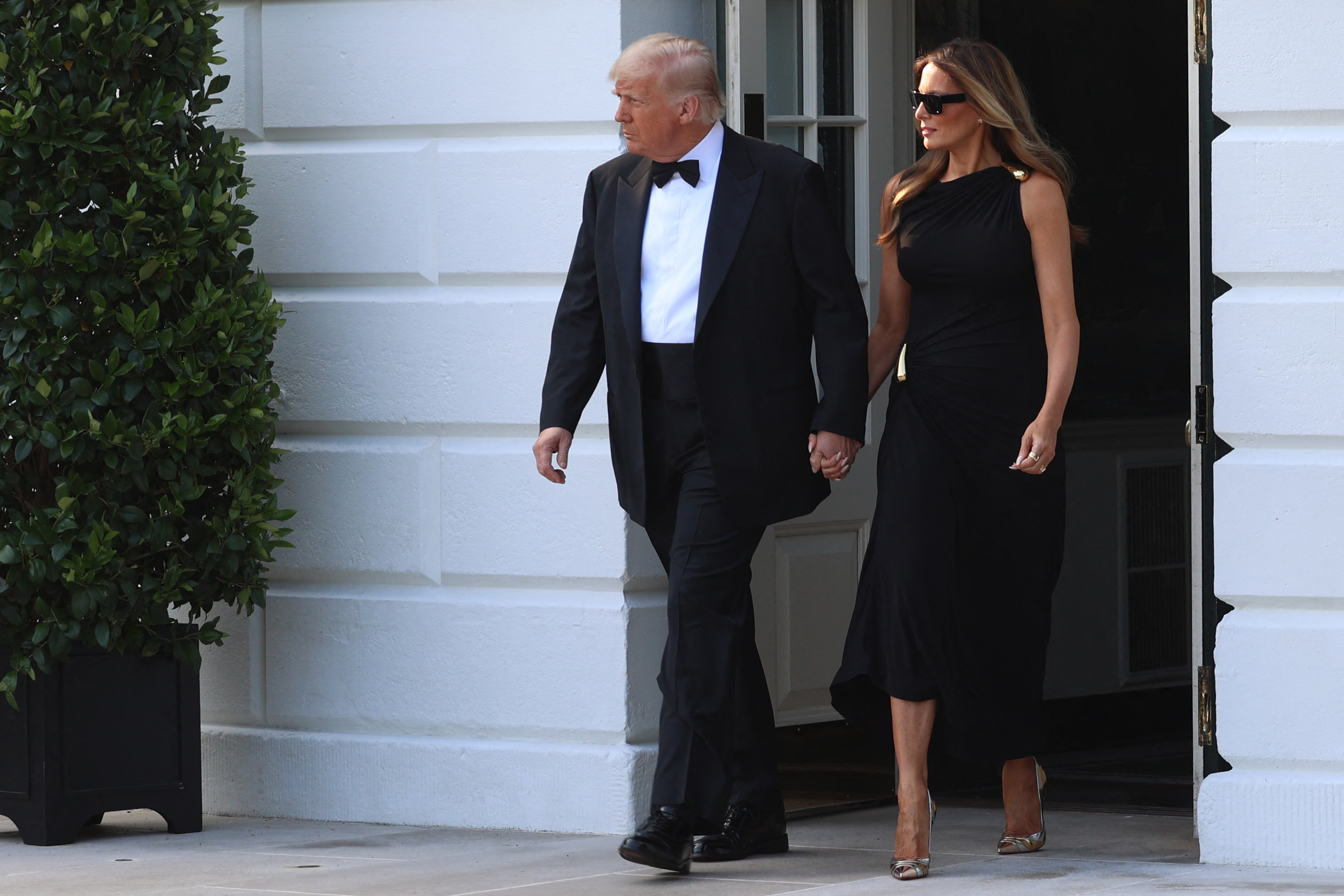 Emerging from the White House, the president and first lady step out together on June 11, 2025, beginning their evening engagement with a show of formality and composure.