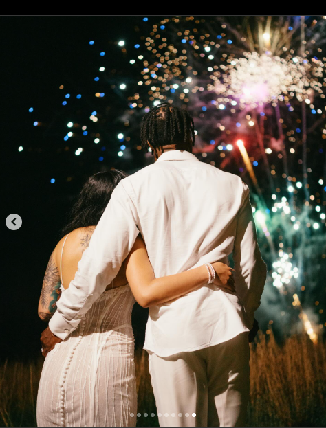 Travis Hunter and Leanna Lenee watch fireworks at the end of their wedding night, dated May 2025 | Source: Instagram/db3_tip