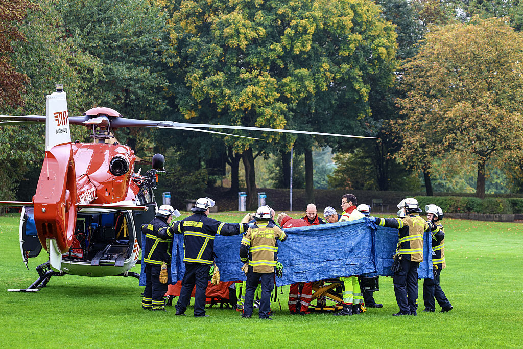 Firefighters and rescue workers transport Iris Stalzer, the newly elected mayor of Herdecke, on a stretcher before she is taken away by helicopter after she was seriously injured in a knife attack in Herdecke, western Germany, October 7, 2025. | Source: Getty Images
