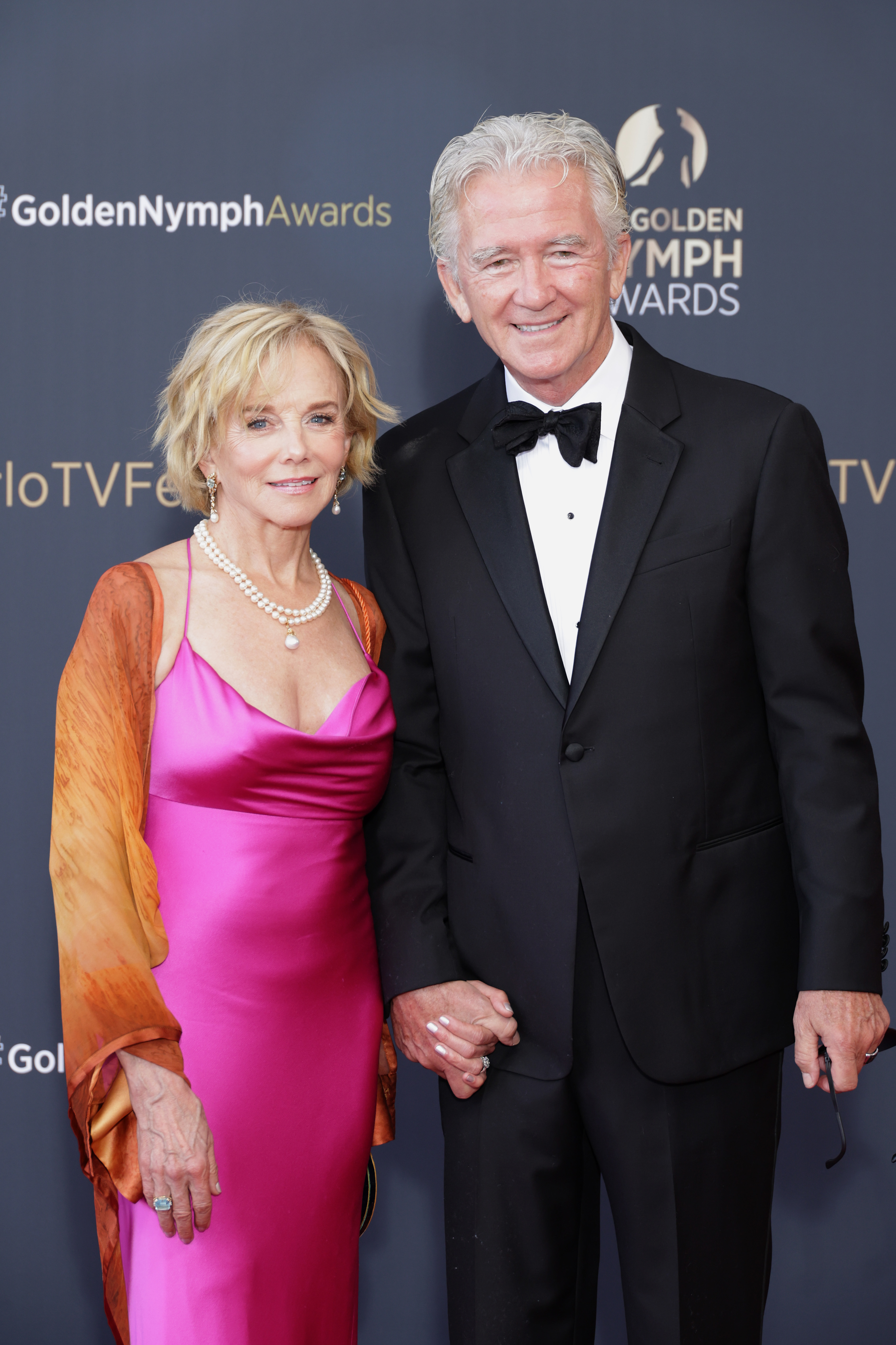 Holding hands with partner Patrick Duffy at the "Nymphes D'Or - Golden Nymphs" Award Ceremony in Monte-Carlo on June 20, 2023, 67-year-old Linda Purl turned heads in a vibrant magenta satin gown draped with a warm sunset-orange shawl. A classic pearl necklace and matching earrings accentuated her radiant smile and luminous complexion, while a tousled, soft blonde bob framed the distinguished elegance of her late 60s. | Source: Getty Images
