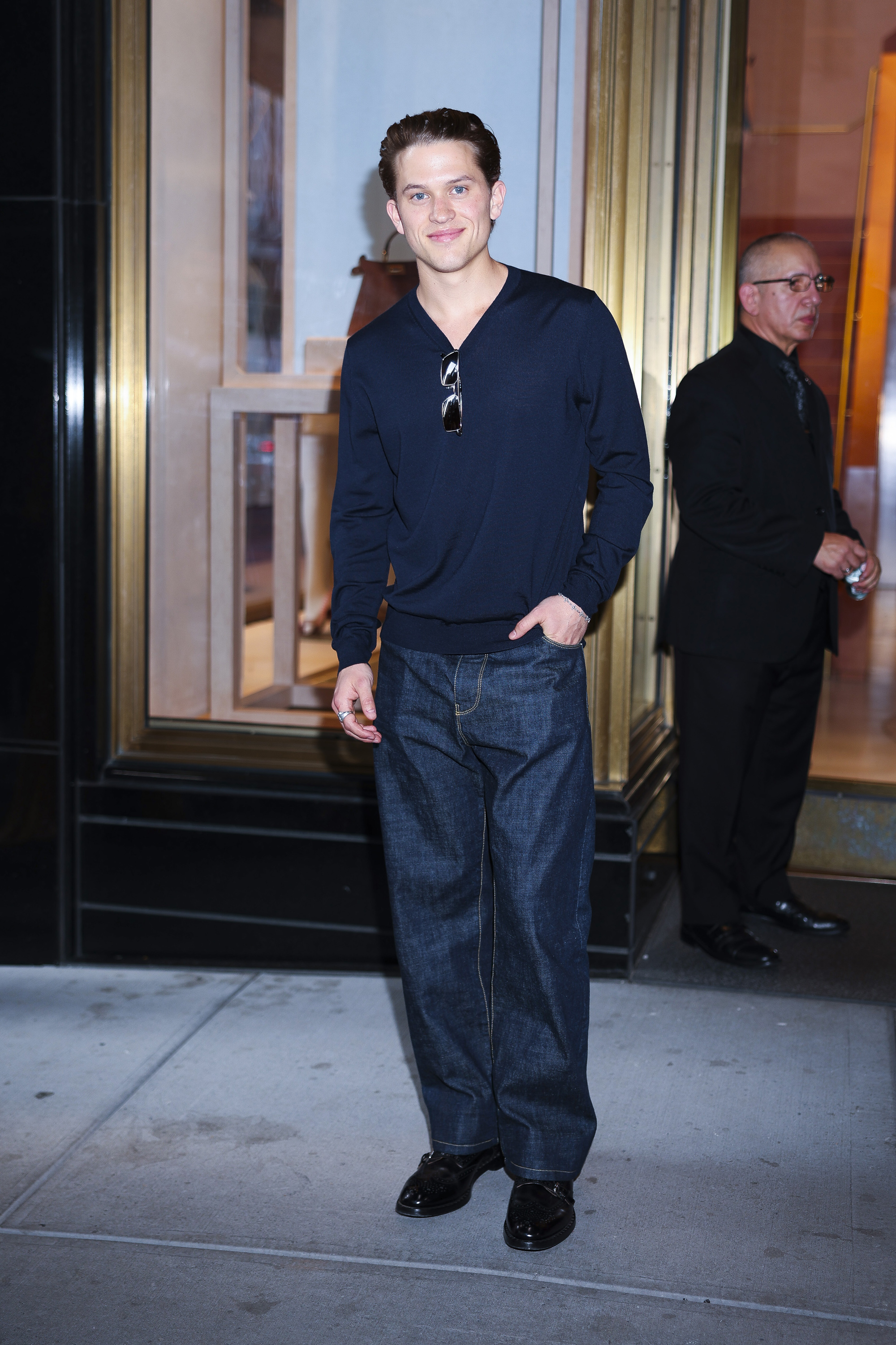 Deacon Reese Phillippe attends Fendi's Baguette 26424 Re-Edition event in Midtown New York City, wearing a dark sweater, wide-leg jeans, and glossy black shoes. | Source: Getty Images