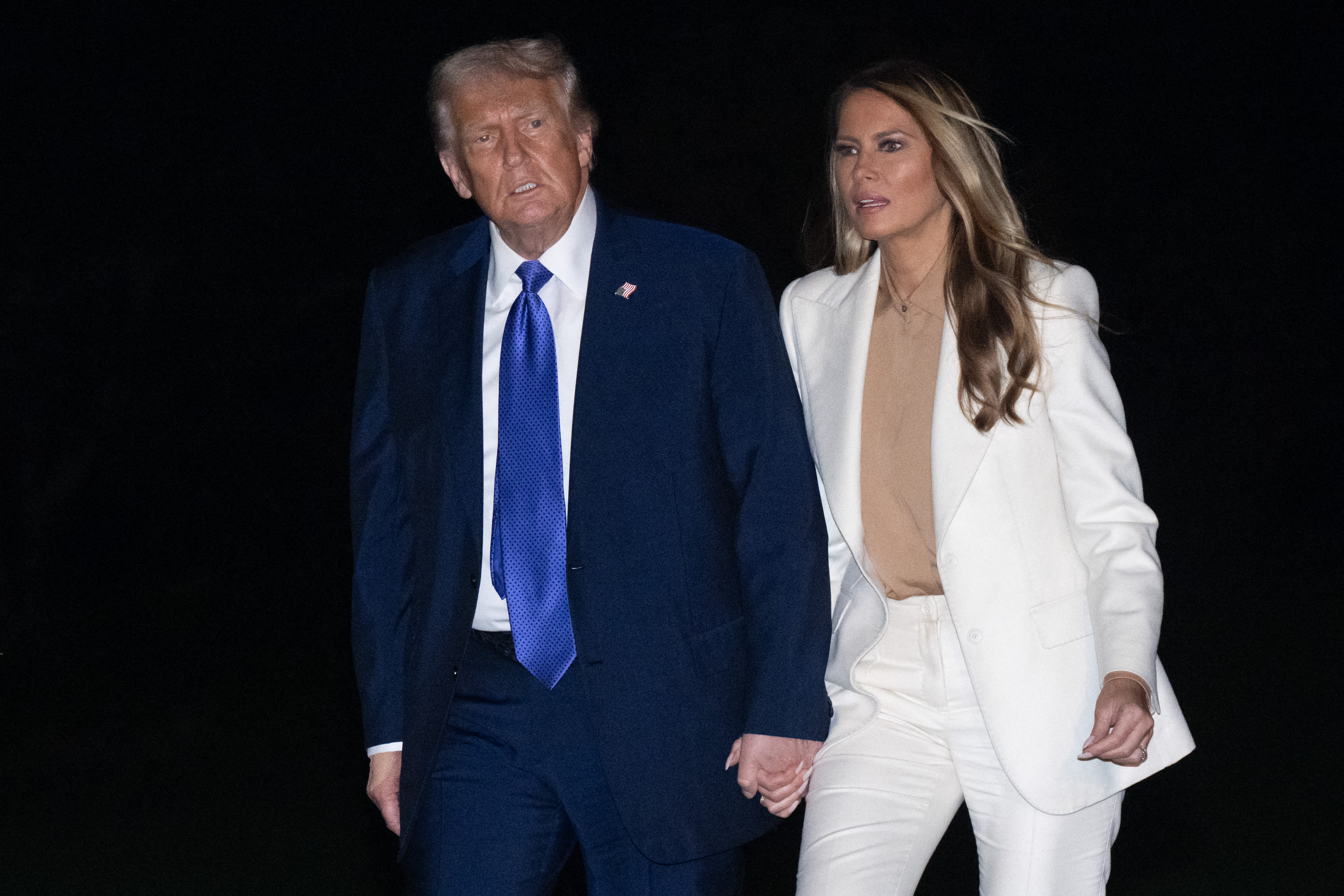 President Donald Trump and First Lady Melania walk on the South Lawn of the White House in Washington, DC, on September 23, 2025 | Source: Getty Images