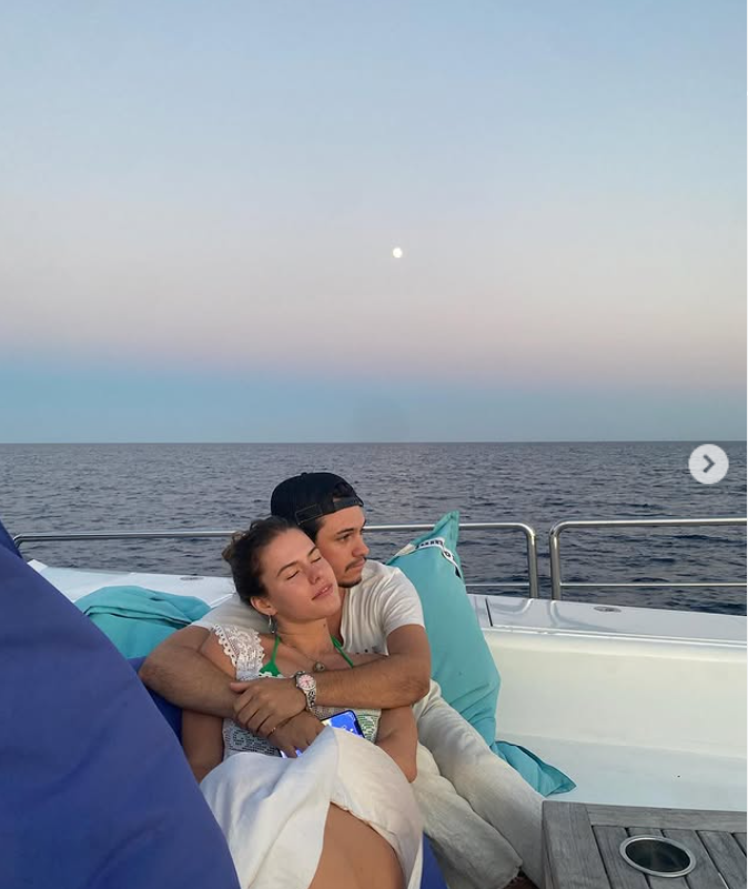 Dylan Lee wrapped his arms around Paula Bruss as the couple relaxed together on a boat in 2022, several years into the romance that began when they were neighbors in Malibu. | Source: Instagram/babybruss