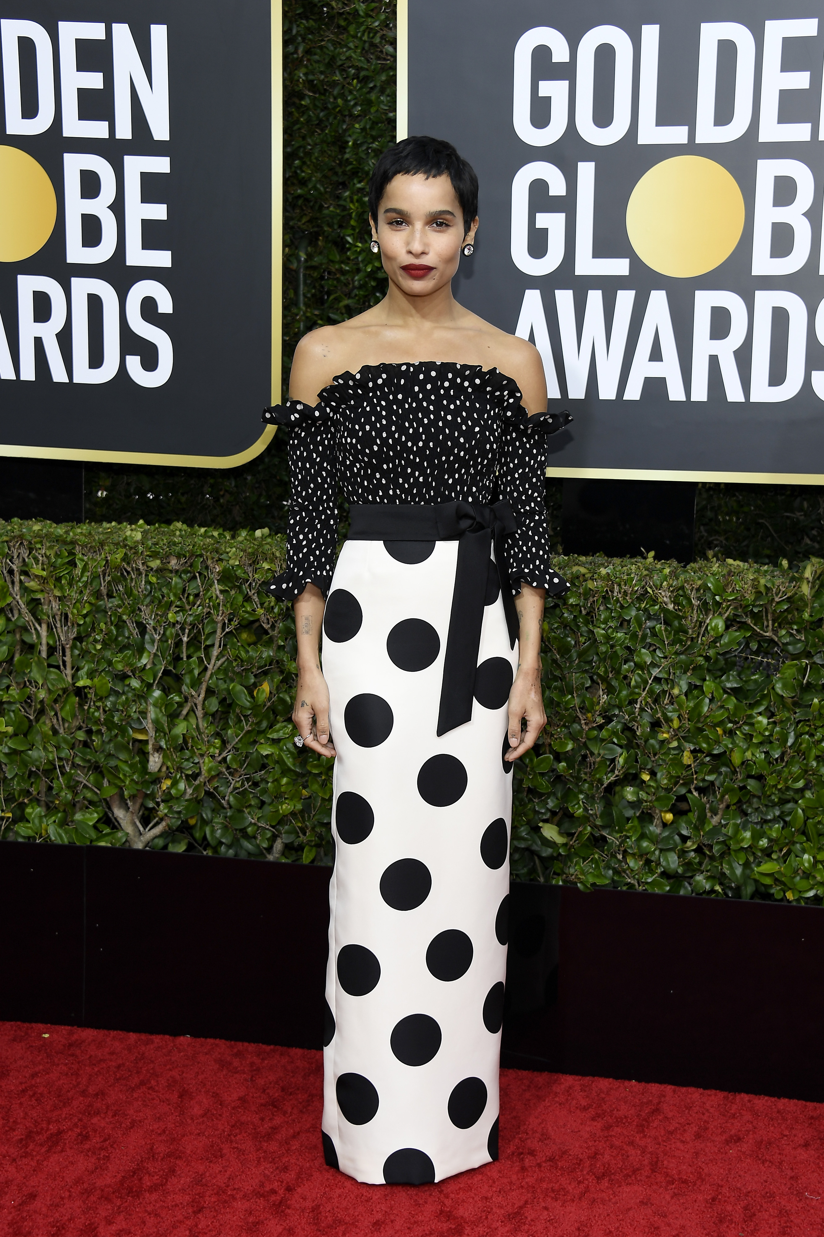 Zoë Kravitz arrived at the 77th Annual Golden Globe Awards at the Beverly Hilton Hotel on January 5. She wore a playful off-the-shoulder Saint Laurent gown with a polka dot print in contrasting sizes, finished with a black waist tie, diamond studs, and a bold red lip.