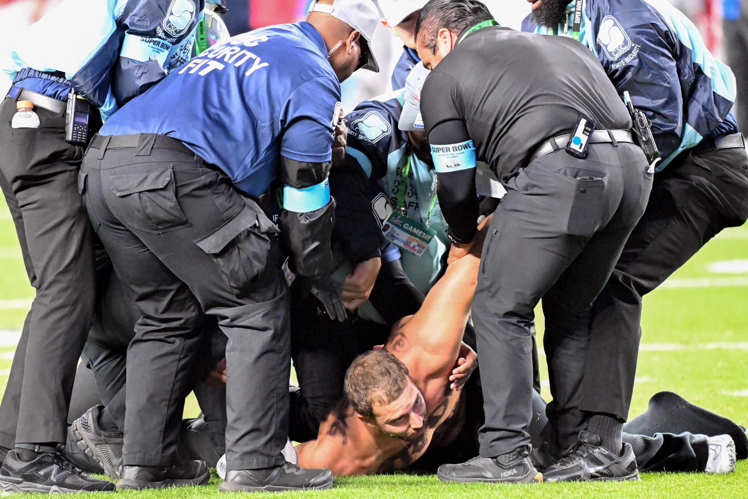 Alex Gonzalez is detained by security after streaking on the field during Super Bowl LX at Levi's Stadium on February 8, 2026, in Santa Clara, California | Source: Getty Images