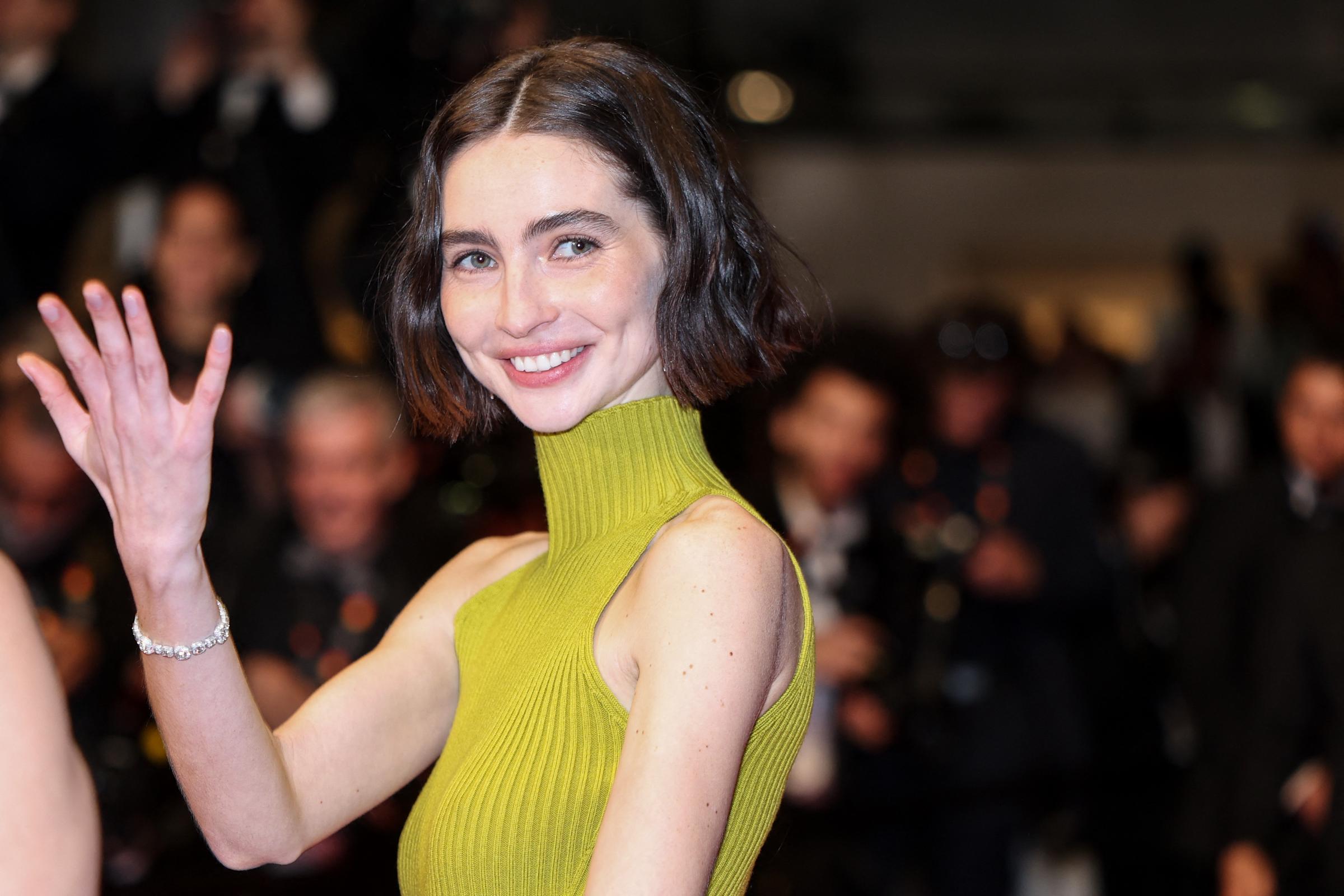 Meadow Walker waves to photographers during "The Fast and the Furious" anniversary screening at Cannes | Source: Getty Images