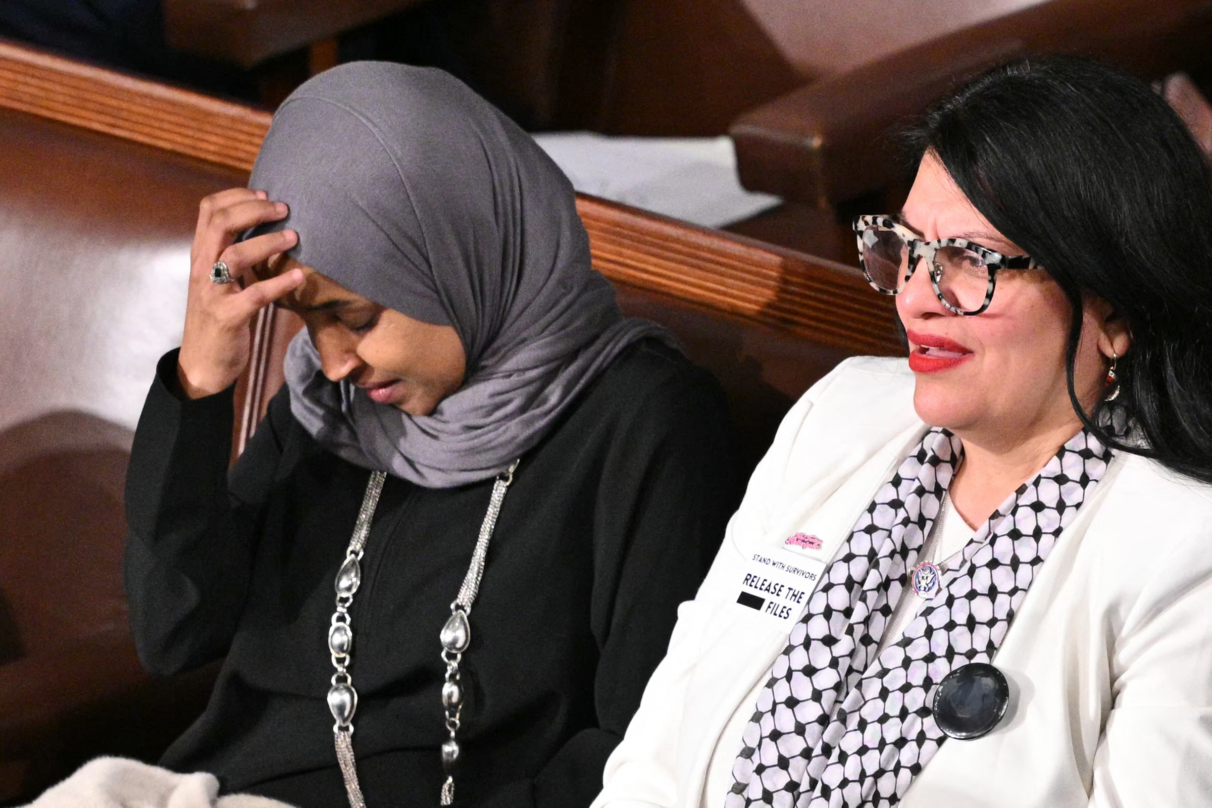 Rep. Ilhan Omar and Rep. Rashida Tlaib look on as President Donald Trump delivers his State of the Union address at the U.S. Capitol in Washington, DC, on February 24, 2026. | Source: Getty Images