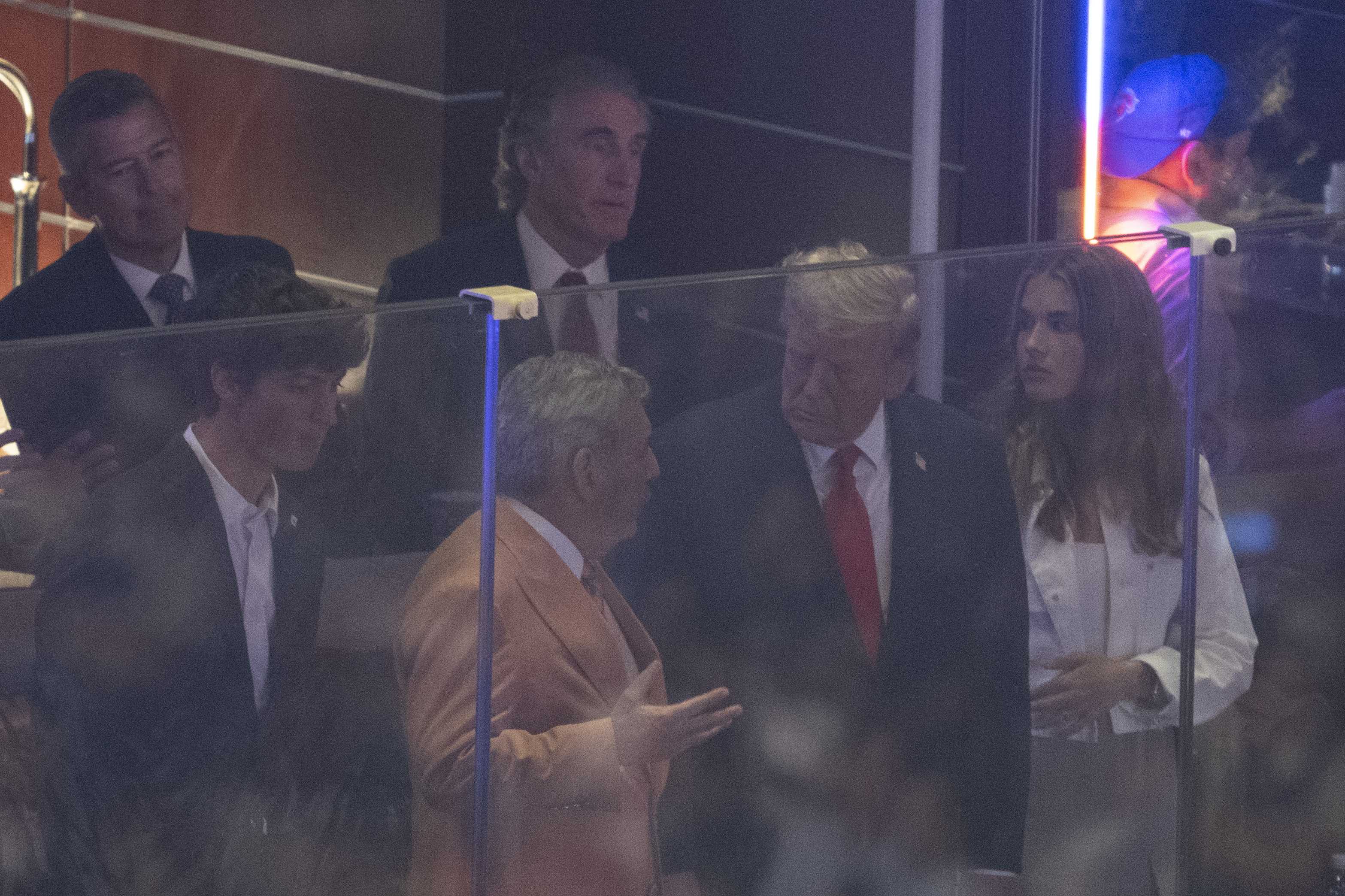 Donald Trump speaks with Madison Square Garden owner James Dolan while attending Game 3 of the NBA Finals alongside granddaughter Kai Trump. A later lip-reading analysis of the courtside conversation sparked widespread interest online. | Source: Getty Images