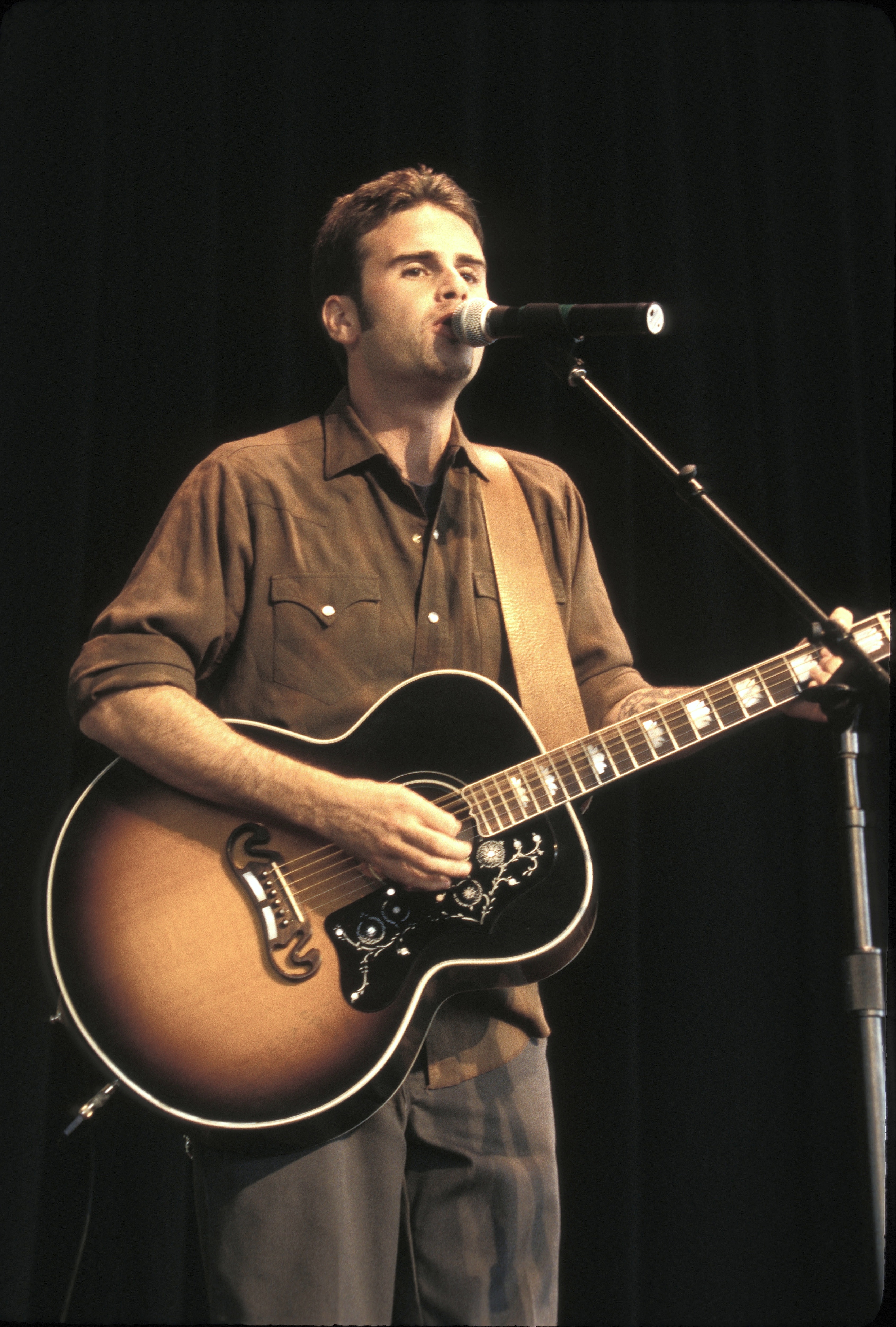 The former star performs with a guitar years after first picking up the instrument at age 12. The future actor once said music—not acting—was always his first love. | Source: Getty Images